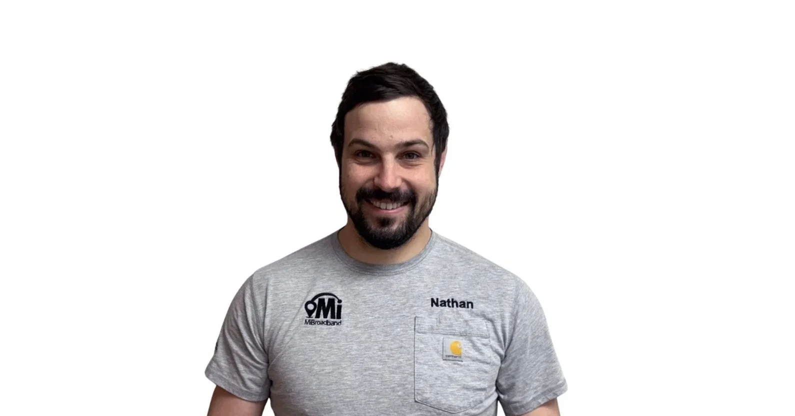 A smiling man with dark hair, a beard, wearing a gray t-shirt with 'Nathan' embroidered on it, standing against a white background.