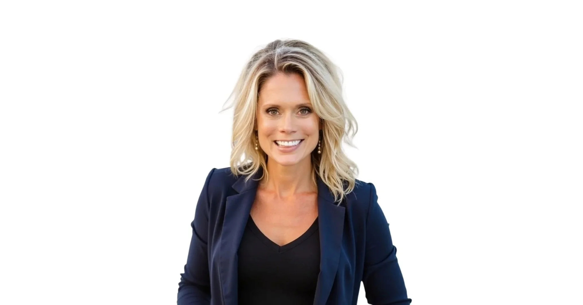 Headshot of a smiling woman with blonde wavy hair, wearing a dark blazer and a black top, against a plain white background.
