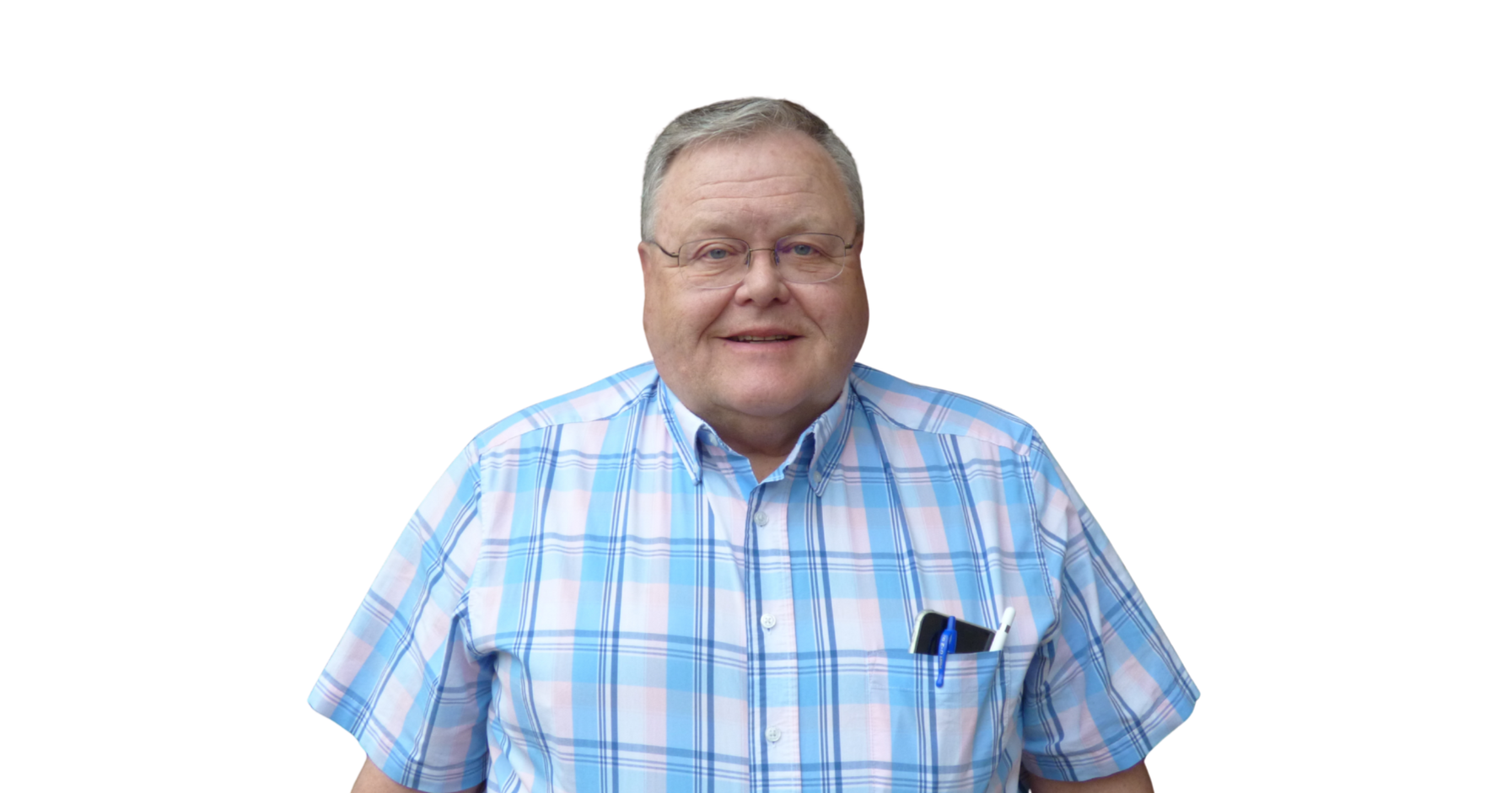 A middle-aged man with glasses and a light-colored short hair, smiling, wearing a blue plaid button-up shirt with pens in his chest pocket, standing against a plain white background.