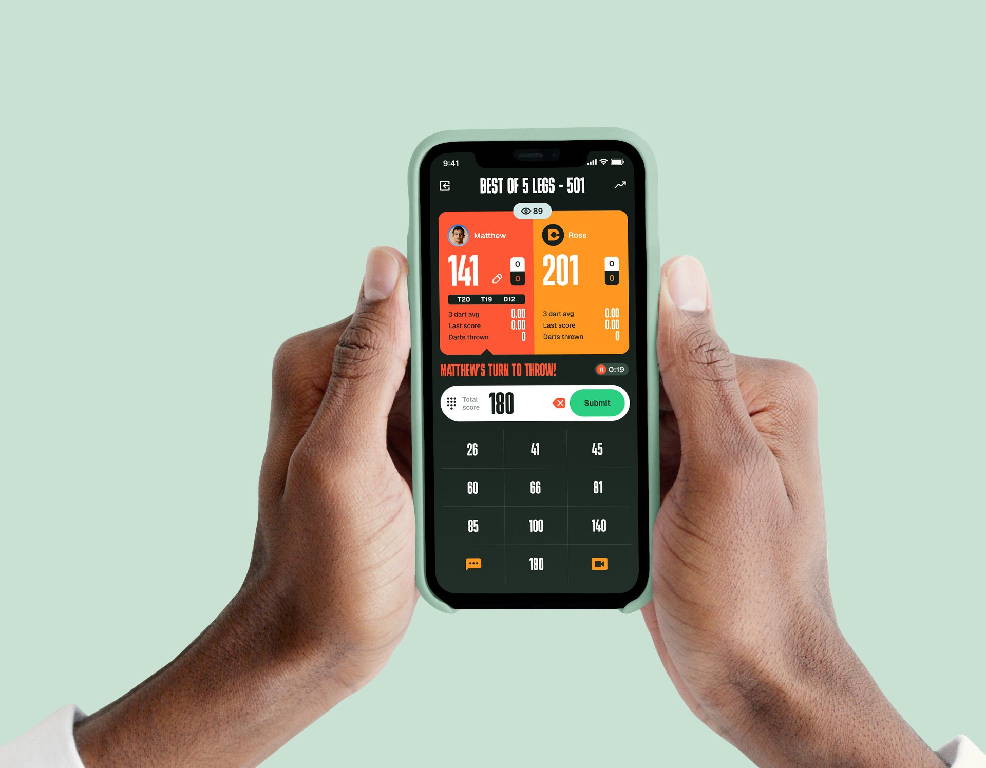Close-up of a person holding a smartphone with a darts game app on the screen displaying scores for two players, Matthew and Ross.