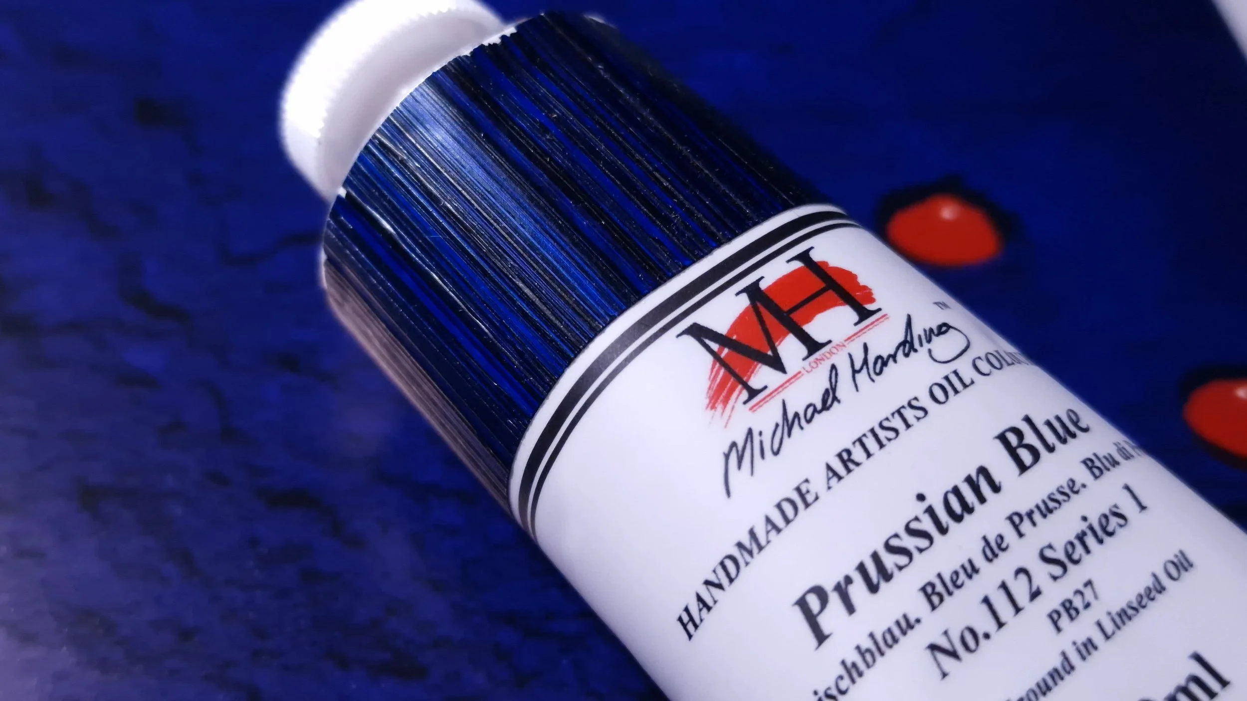 Michael Harding Prussian Blue oil paint labelled PB27, photographed against a deep blue painted surface.