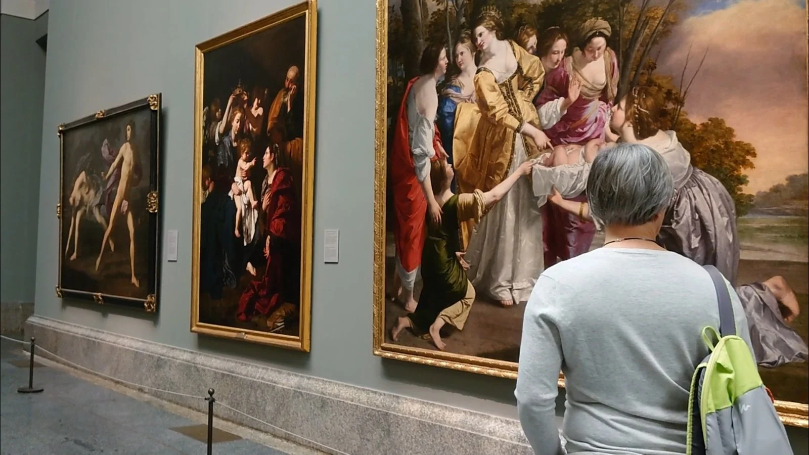 A visitor viewing Old Master paintings in the Louvre Museum, Paris, France.