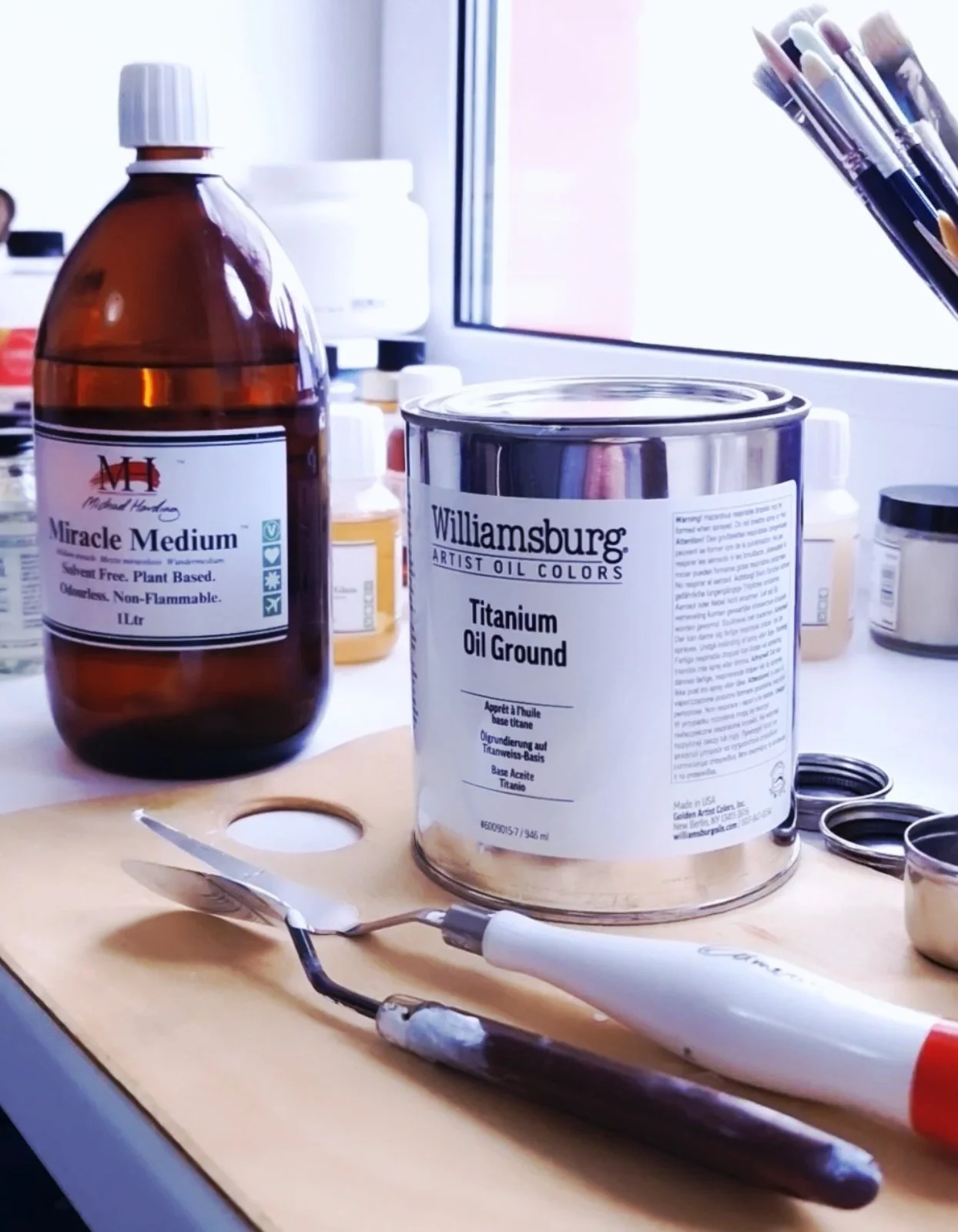 Artists’ grounds, oils, brushes and palette knives in a working studio, representing the material knowledge, tools and practices that form an archive of possibility around the making of art.