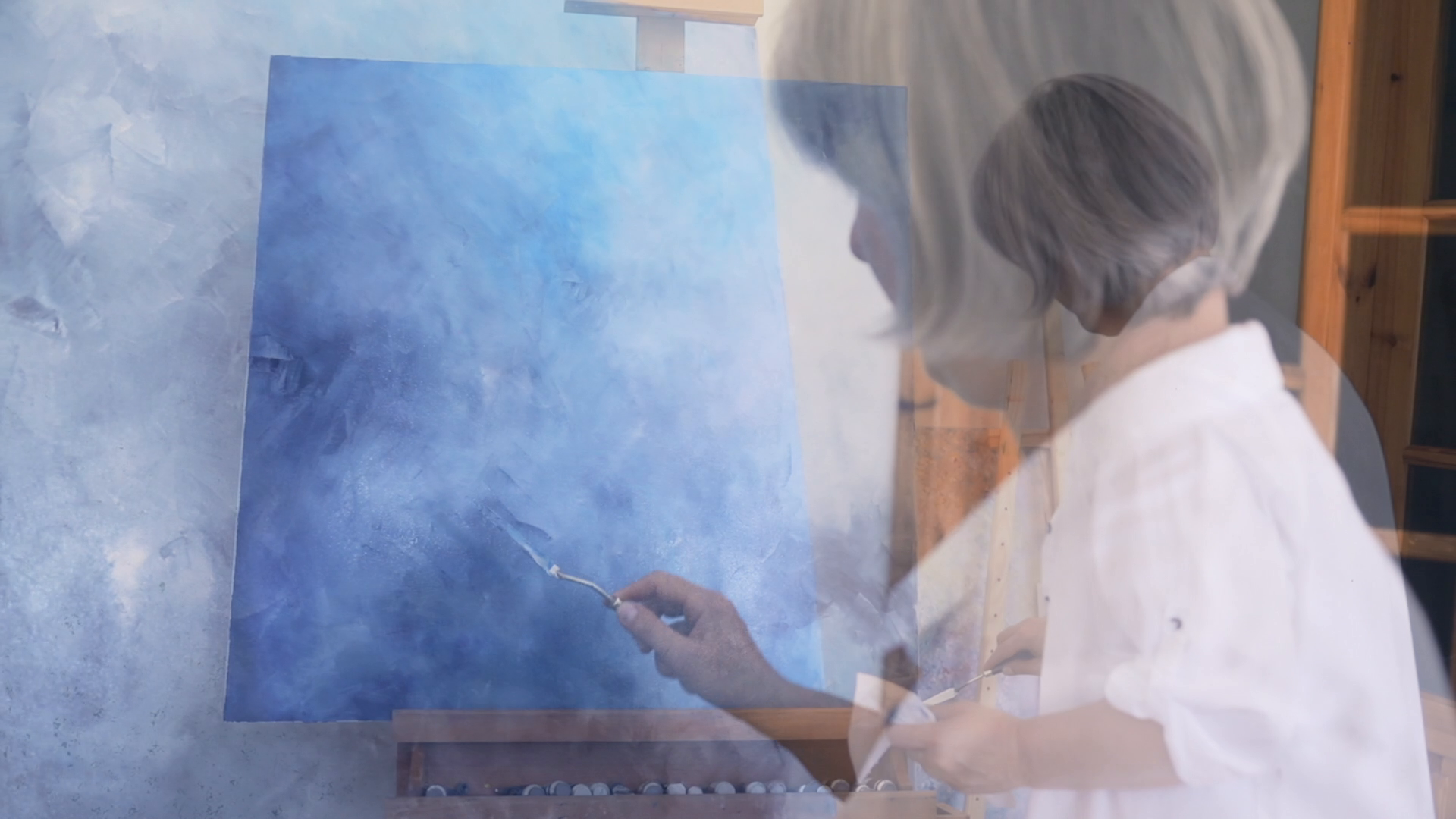 Multiple moments from Veronika Kyrychenko’s oil painting process overlap in a studio video frame.