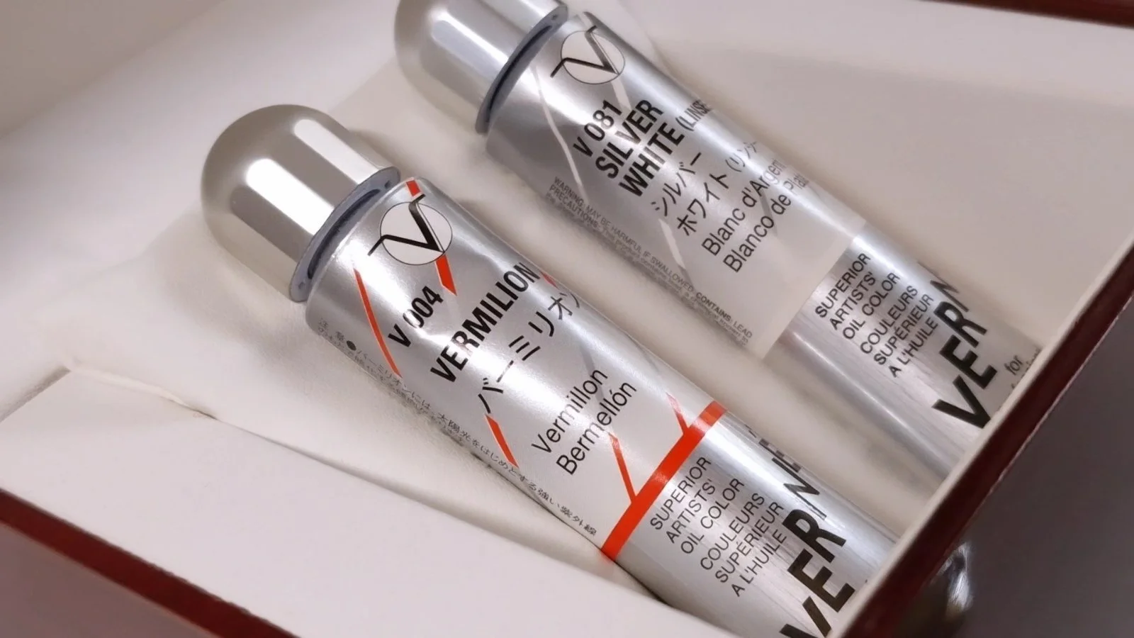 Holbein Vernét Vermilion and Silver White oil paint tubes preserved in a presentation case as part of the Material Memory collection.