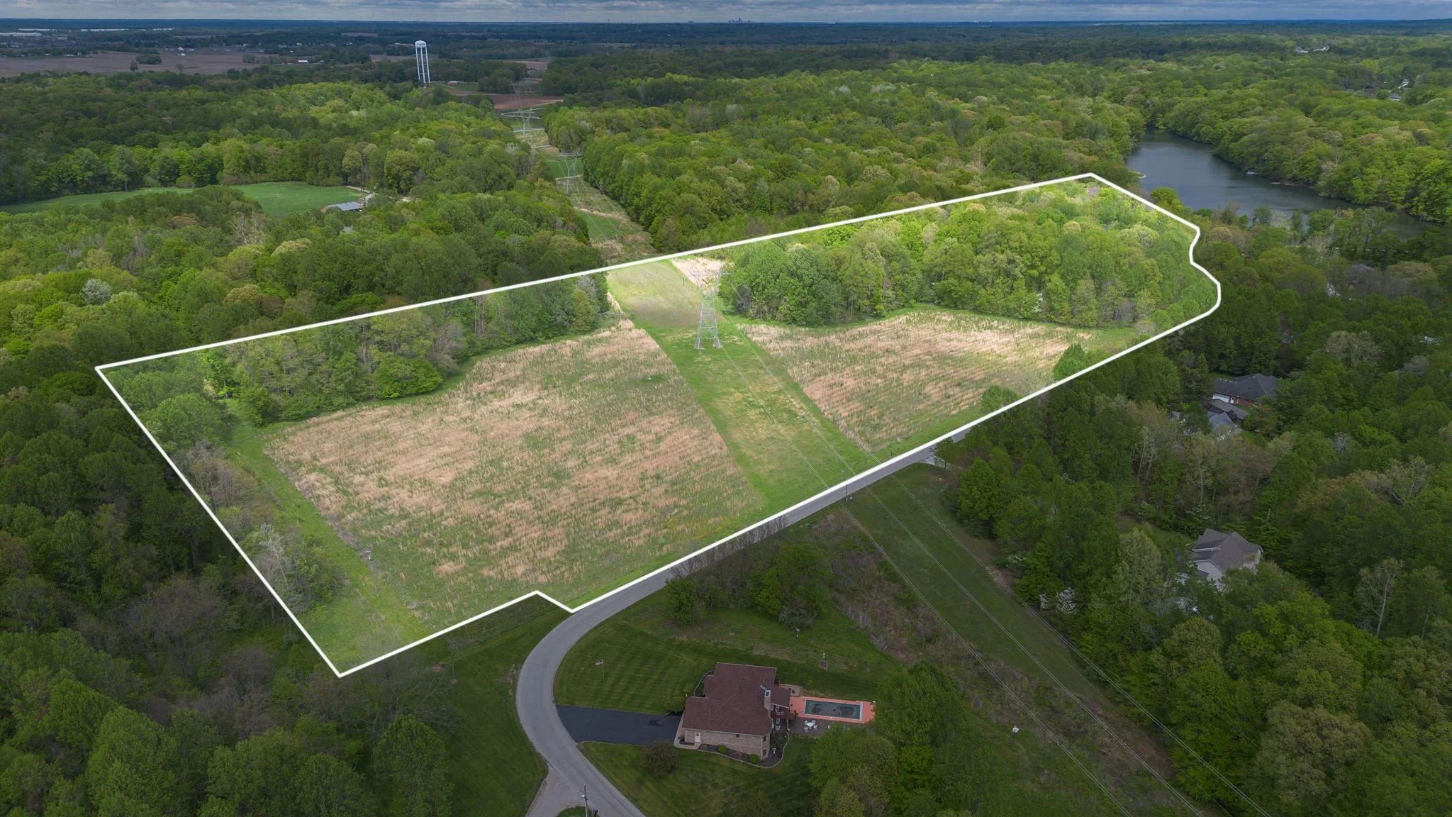 Aerial photograph of a vacant land parcel outlined with a property-line overlay