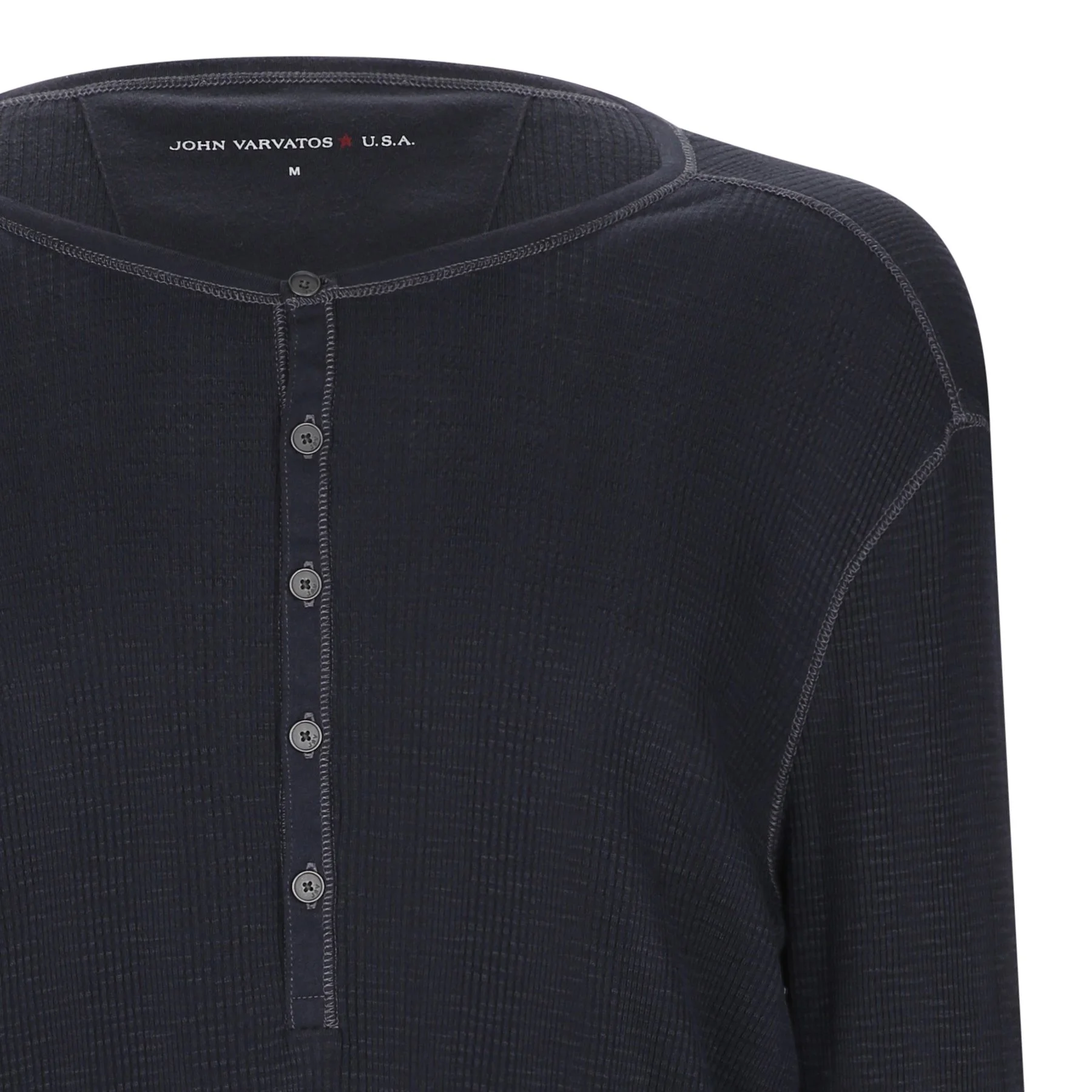 Close-up of a dark navy blue shirt with a button-up front and visible stitching, displayed on a mannequin or hanger.