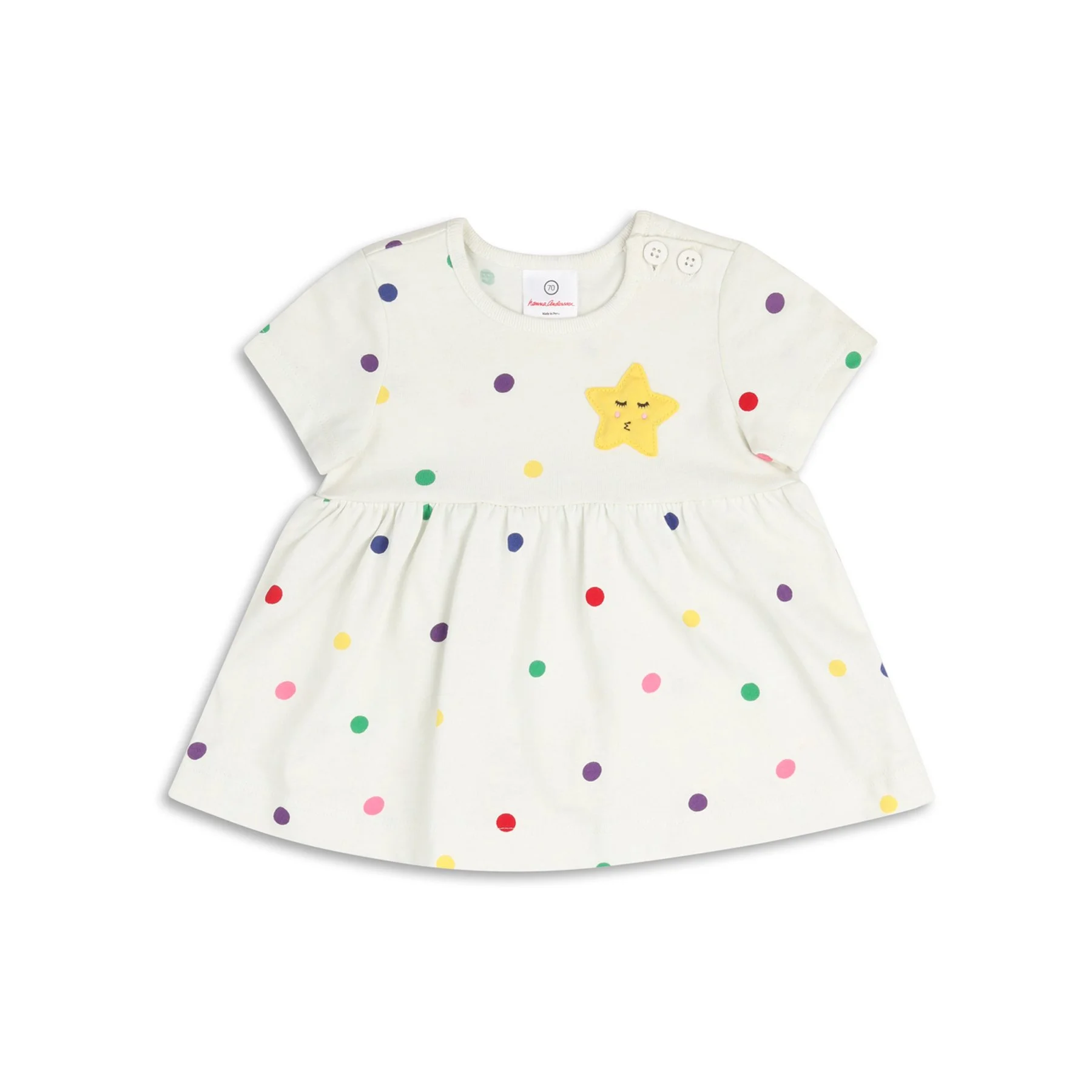 A white dress for a young girl with multicolored polka dots and a yellow star with a face and closed eyes embroidered on the front.