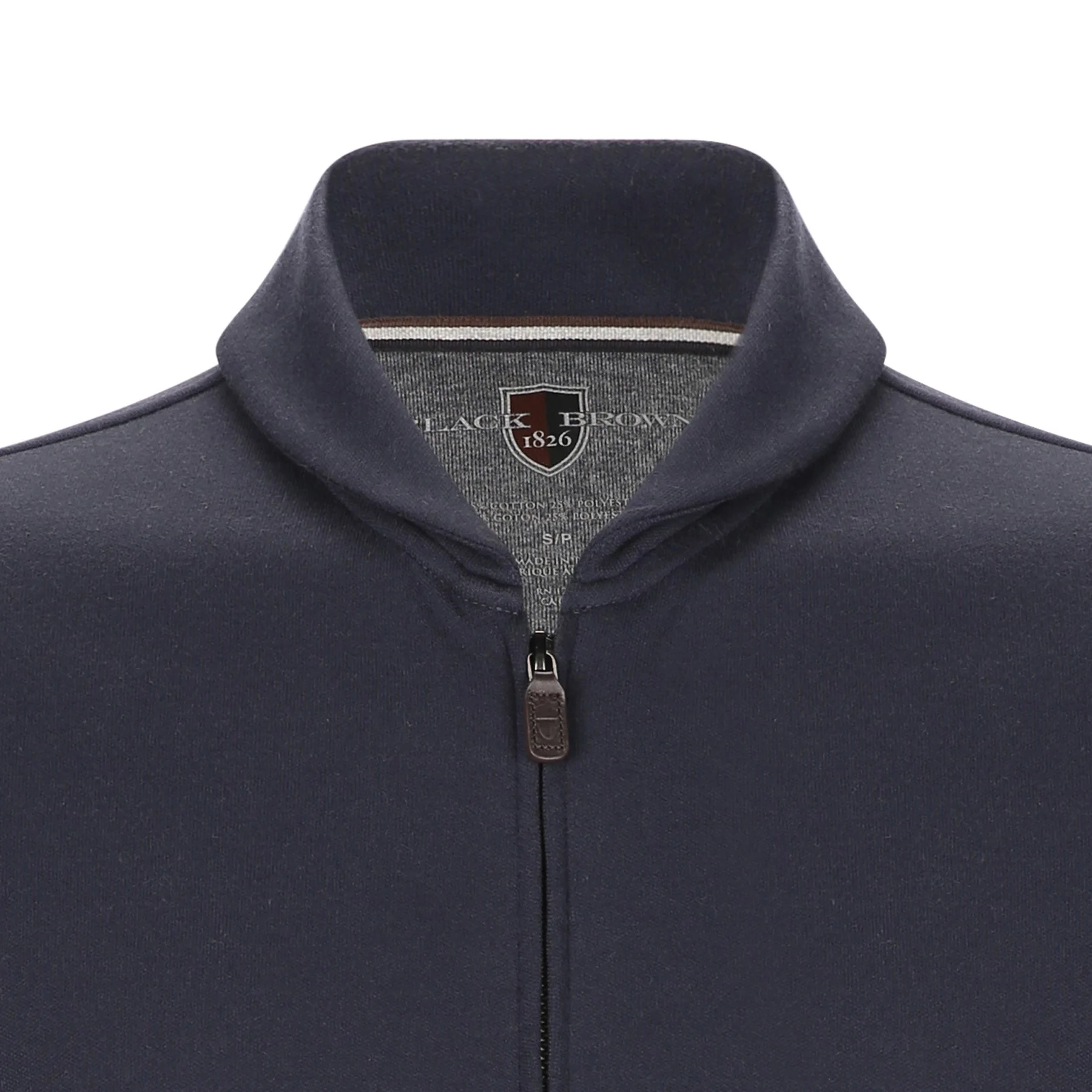 Close-up of a navy blue zip-up polo shirt with a collar, featuring a shield-shaped emblem inside the collar that reads "Black Brown 1826."