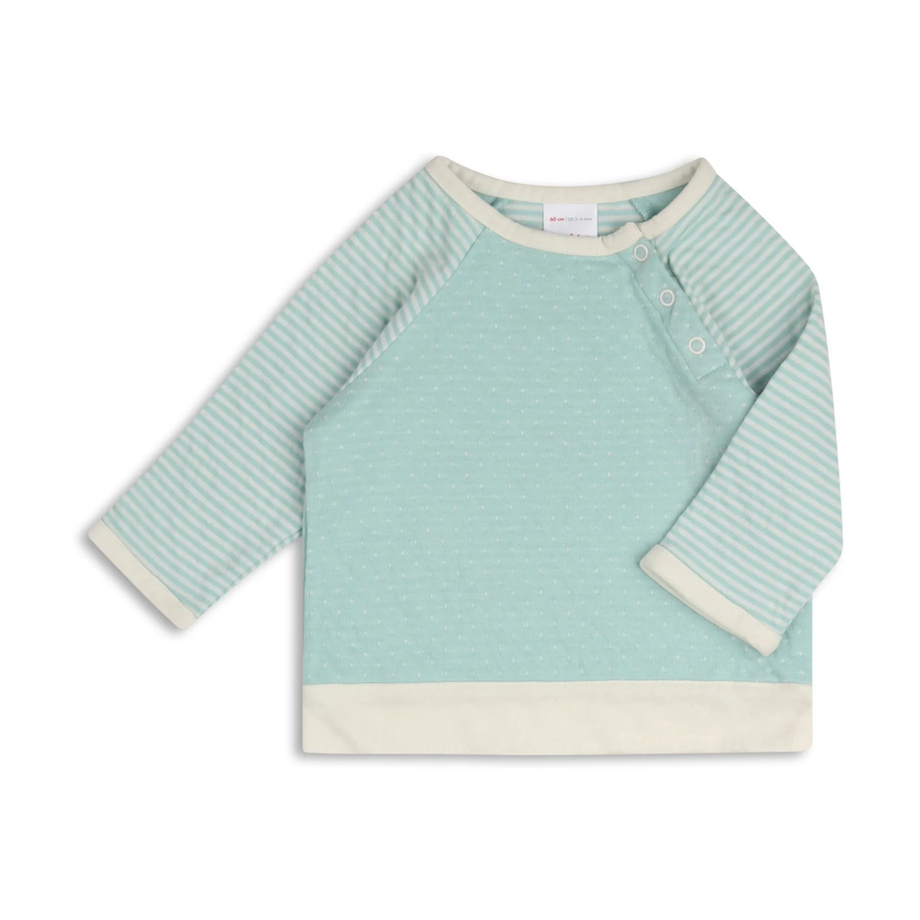 A light mint green long-sleeve baby dress with white trim around the collar and cuffs, featuring small white polka dots and grey and white striped sleeves, with three white snaps on the shoulder.