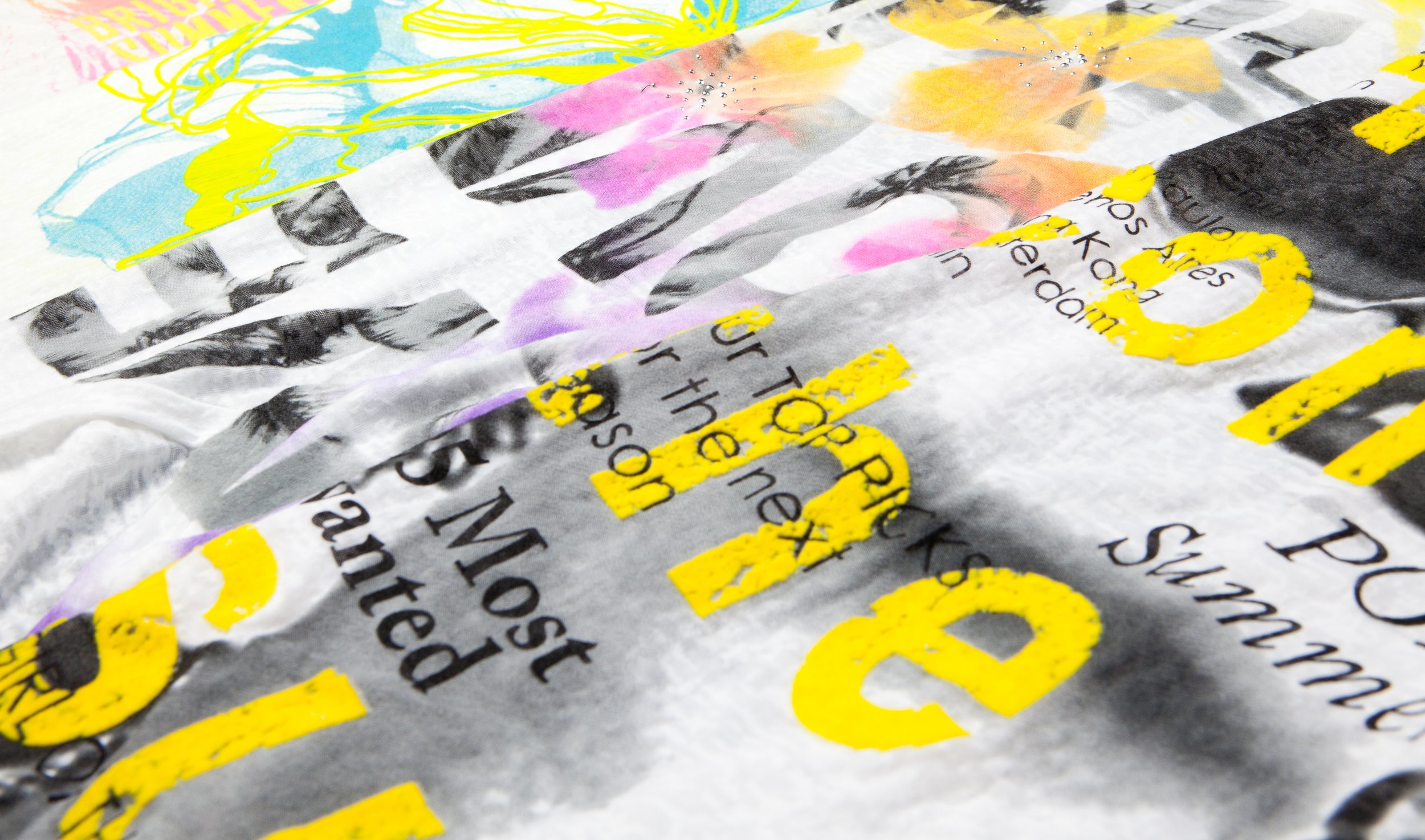 Close-up of crumpled paper with printed text and yellow highlights, some handwritten annotations, and colorful drawings on the paper.