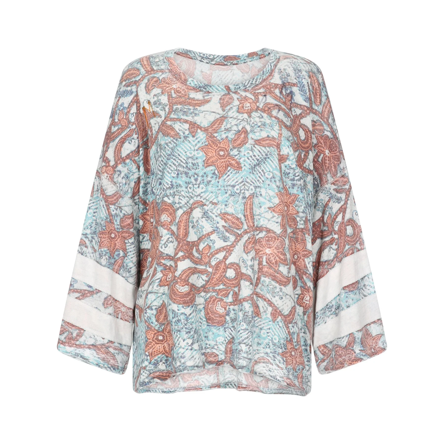 A long-sleeve blouse with a floral and paisley pattern in shades of rust, blue, and white, with a white hem at the bottom.