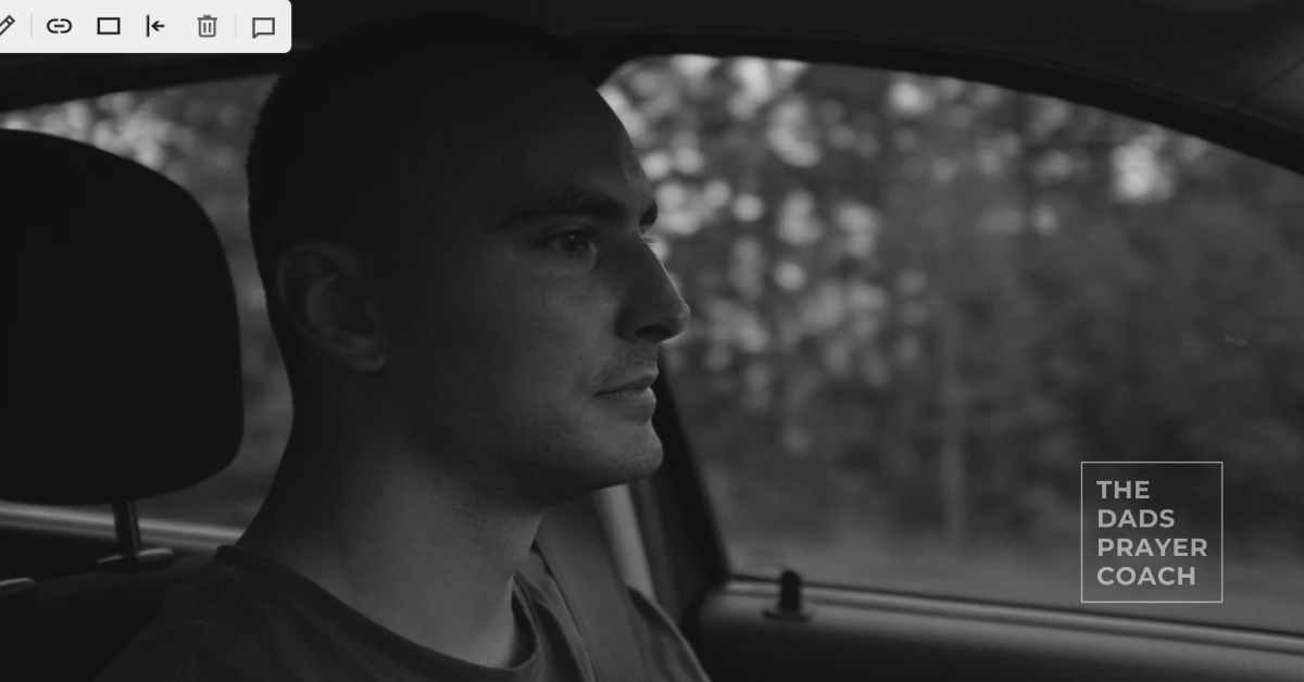Man driving a car with a blank withdrawn stare contemplating