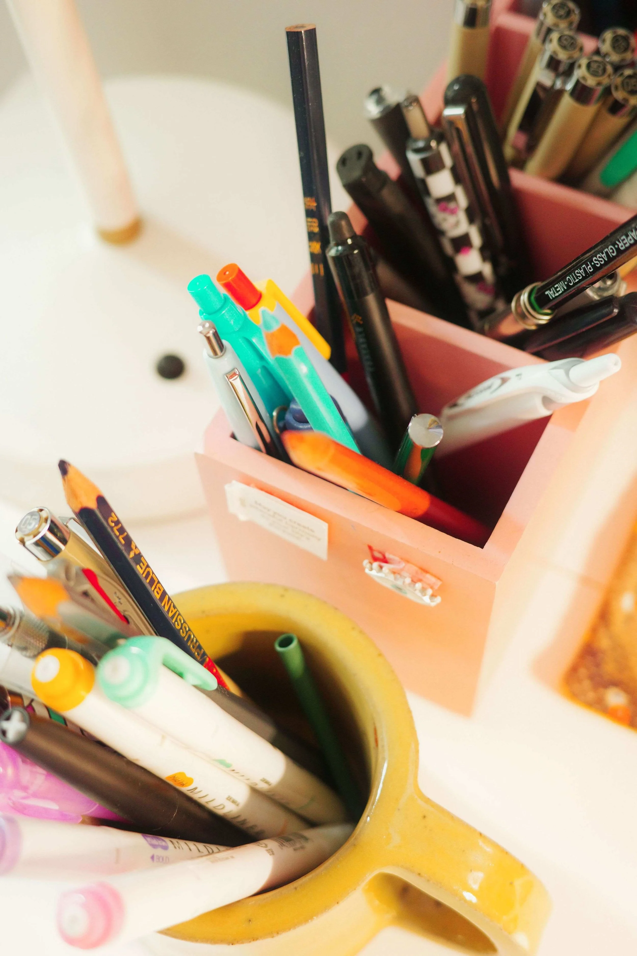 Close-up of art supplies in Denise Holmes’ illustration studio, including markers and tools used for creating children’s book artwork.