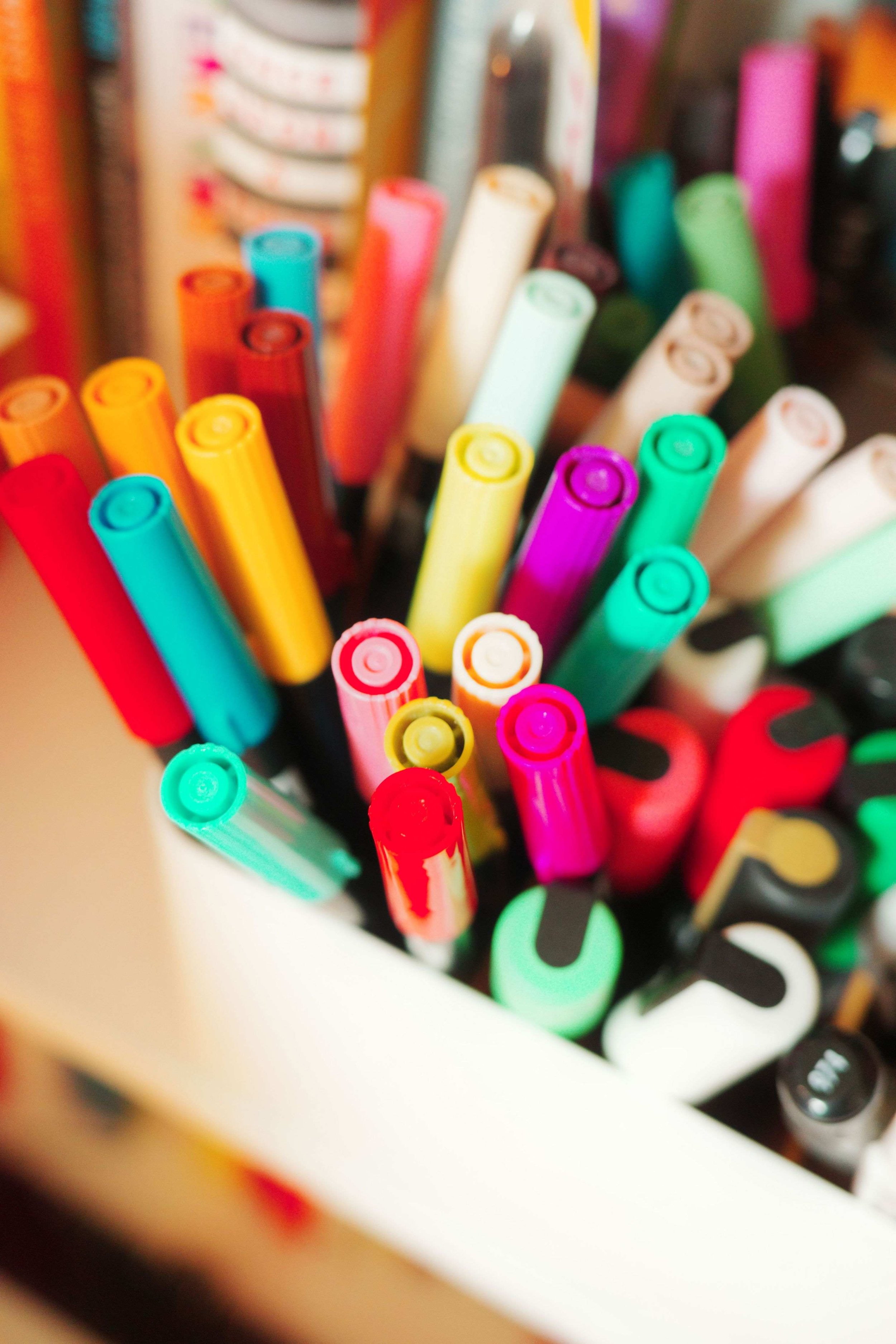 Close-up of colorful markers in Denise Holmes’ illustration studio, showing tools used for creating artwork.