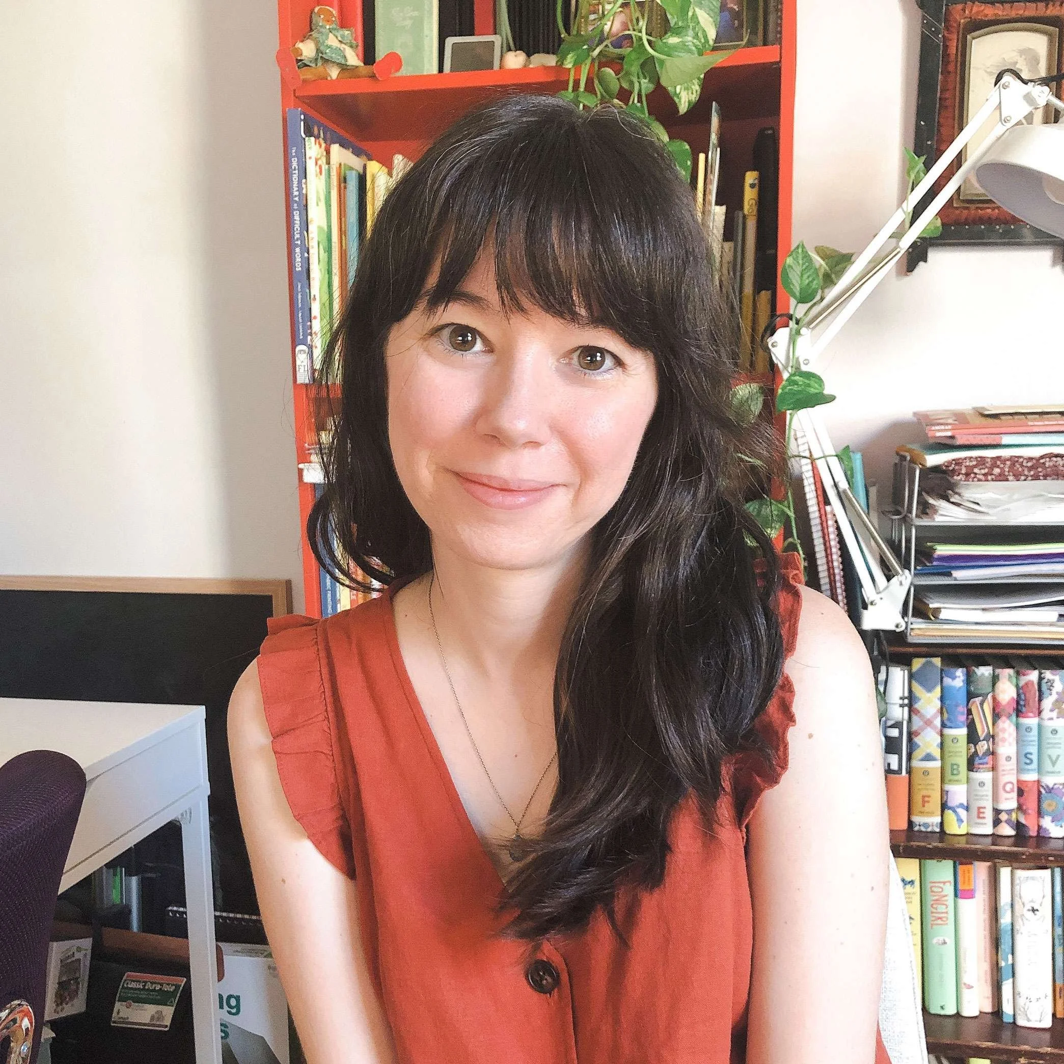 Portrait of Denise Holmes, a children's book illustrator, in her creative workspace.