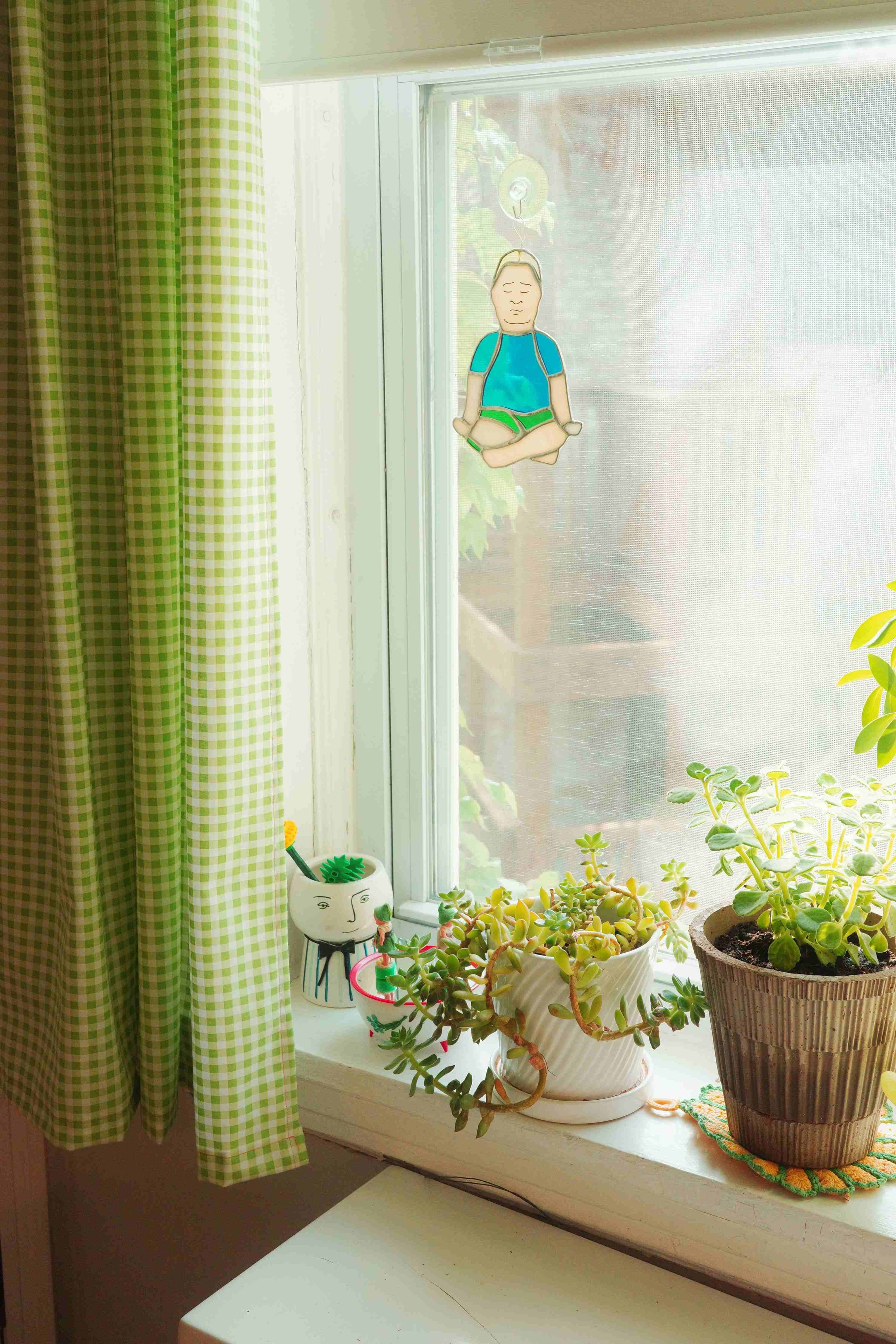 Denise Holmes illustration studio with a bright workspace, plants, artwork, and creative tools for children's book illustration.