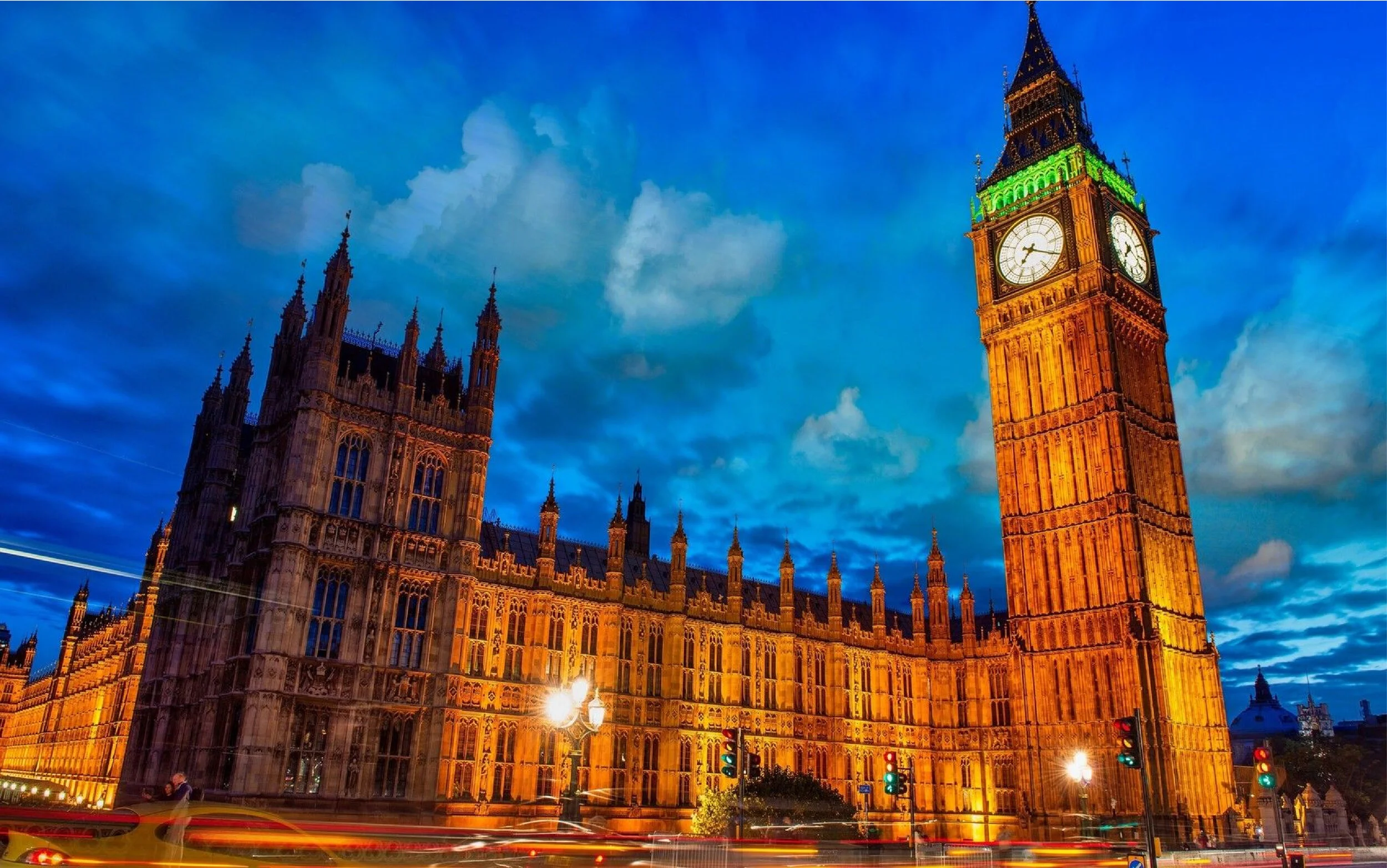 The illuminated Big Ben clock tower and the Palace of Westminster at dusk in London, England.
