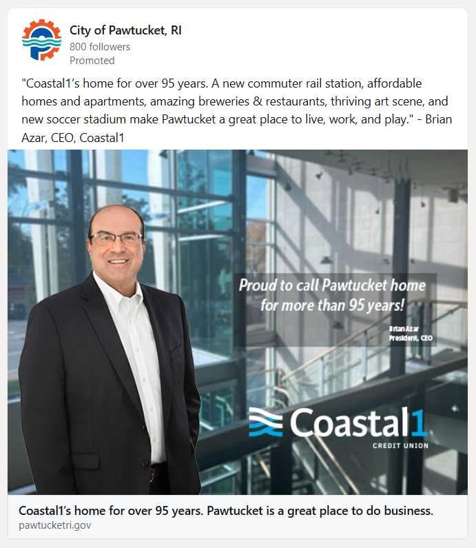 Photograph of Brian Azar, CEO of Coastal1, standing inside a modern building with glass walls and stairs, promoting the city of Pawtucket, Rhode Island, and Coastal1 Credit Union.