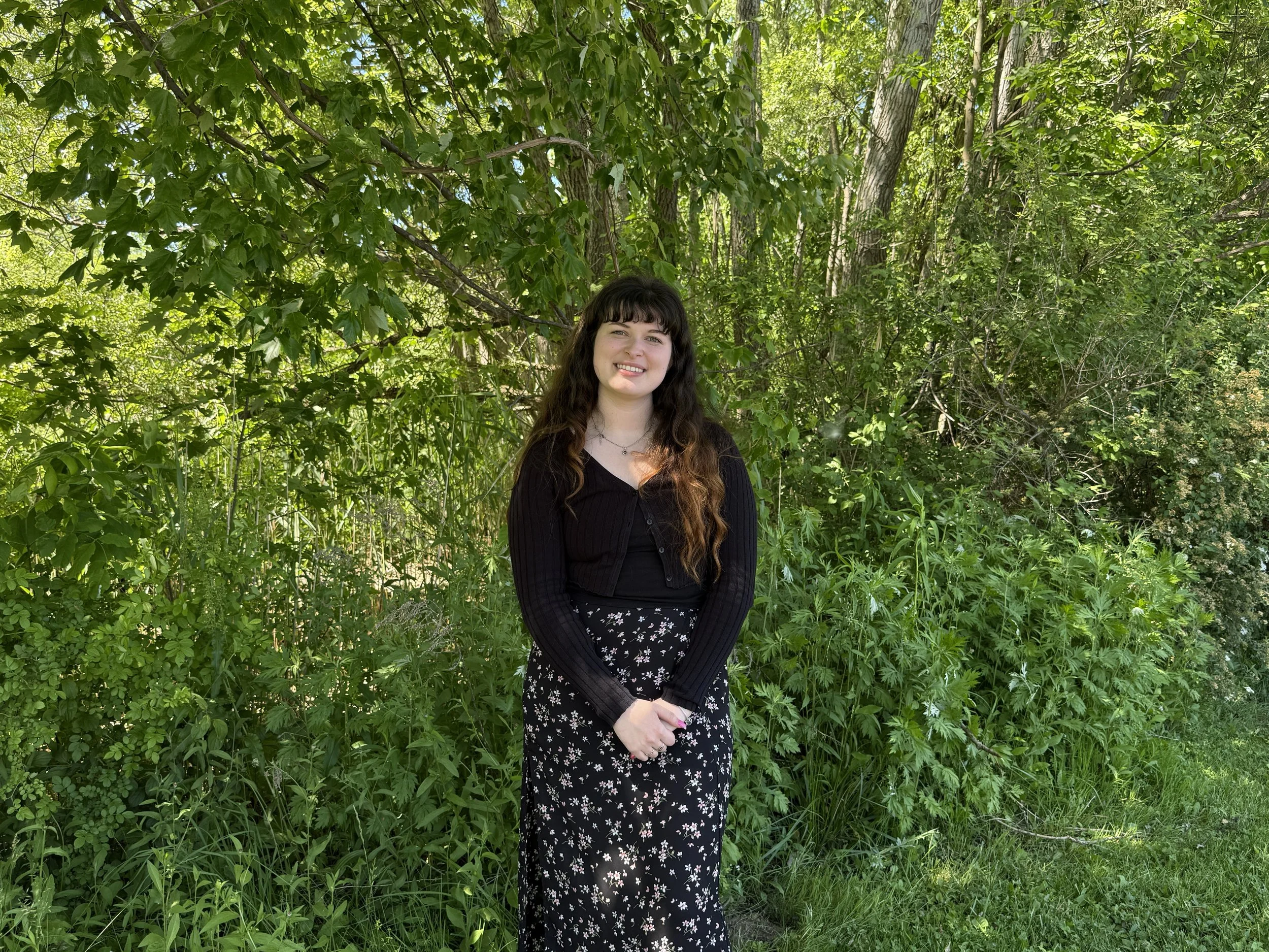 Smiling photo of Katie M., member of NBM