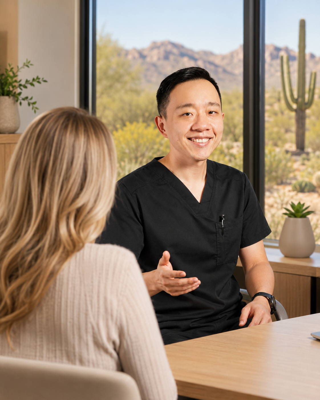Dr. YiQiu Hu discussing personalized medical care with a patient from Buckeye, Arizona
