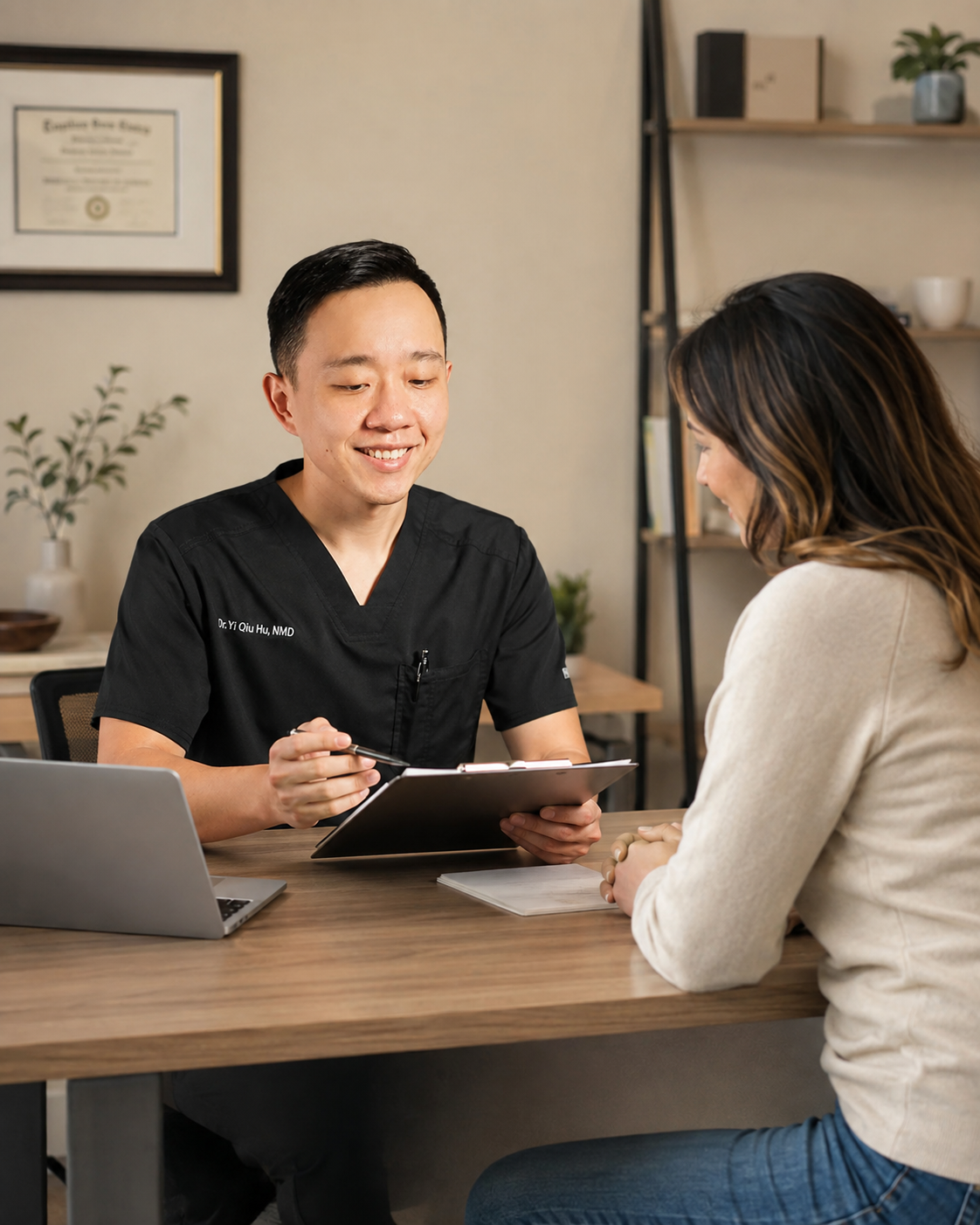 Dr. Hu reviewing medical records with a patient during an Arizona medical marijuana evaluation