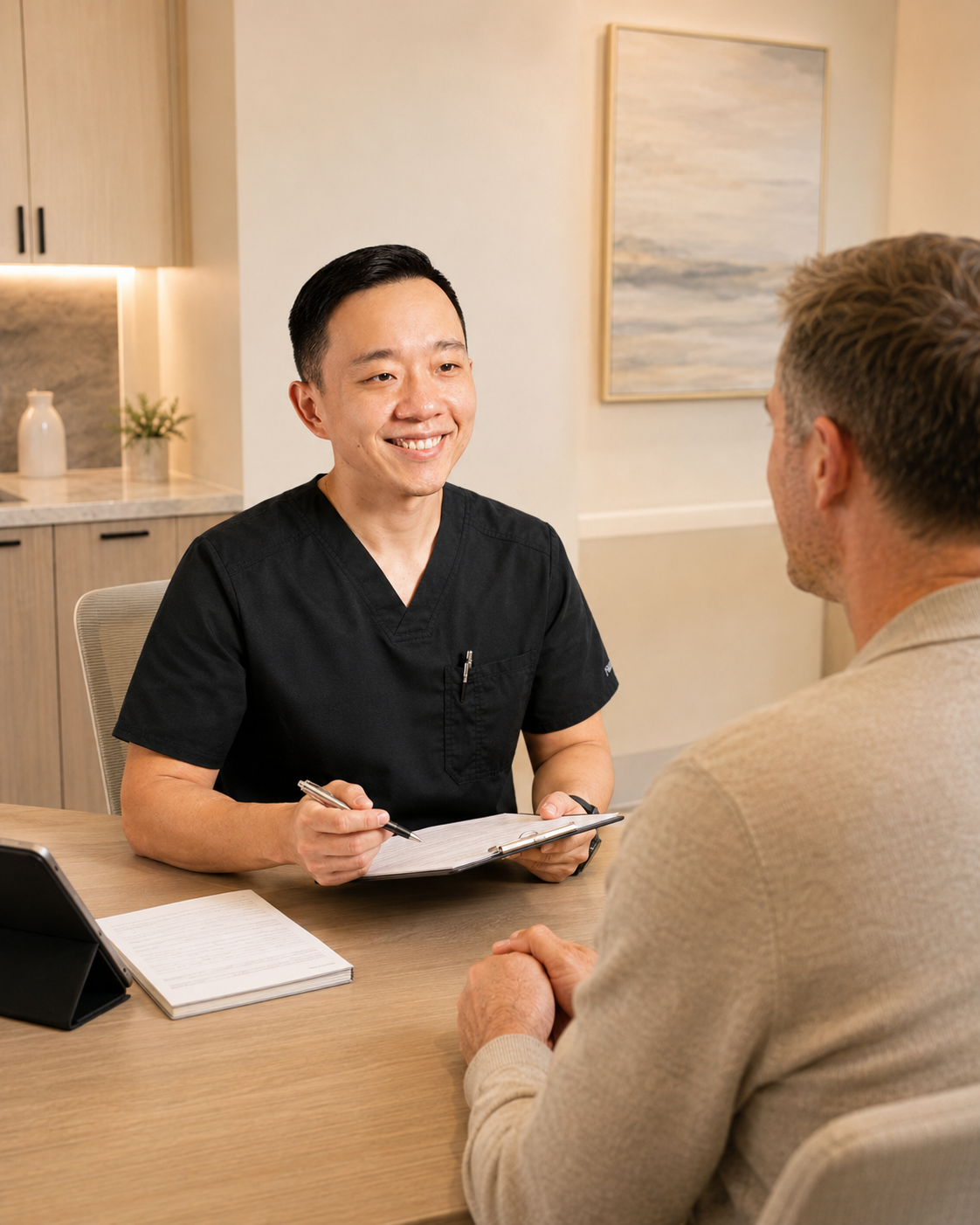Dr. YiQiu Hu reviewing medical history with a patient during a first concierge medicine appointment in Arizona