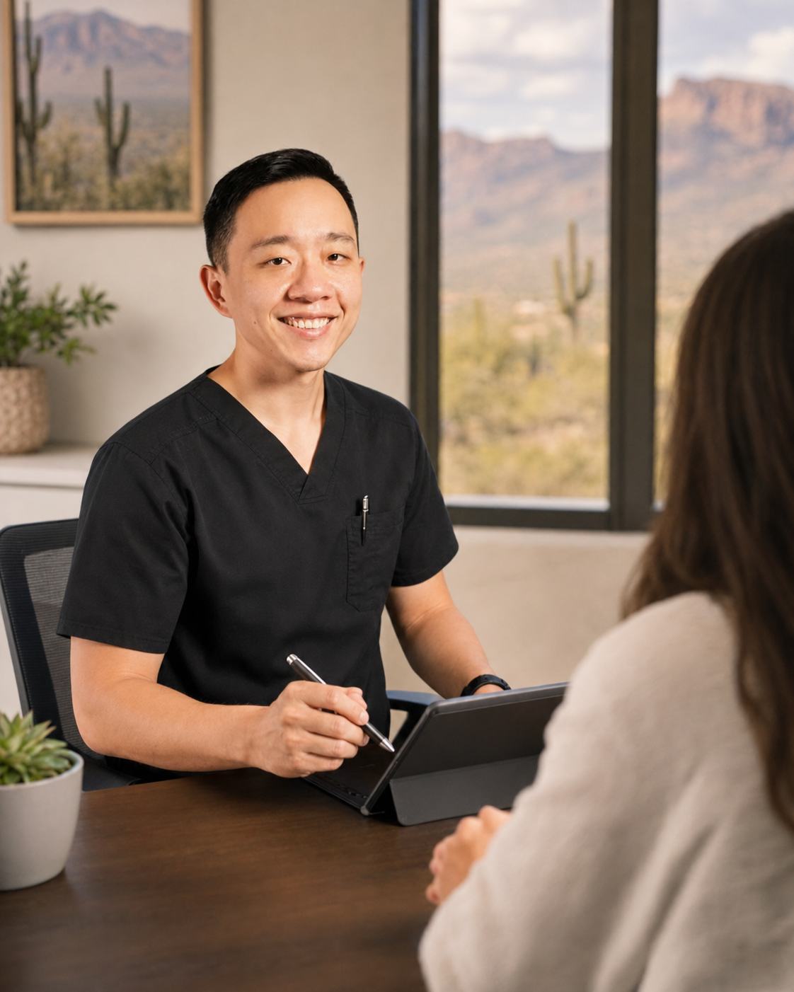 Dr. YiQiu Hu discussing a personalized concierge medical plan with an Arizona patient