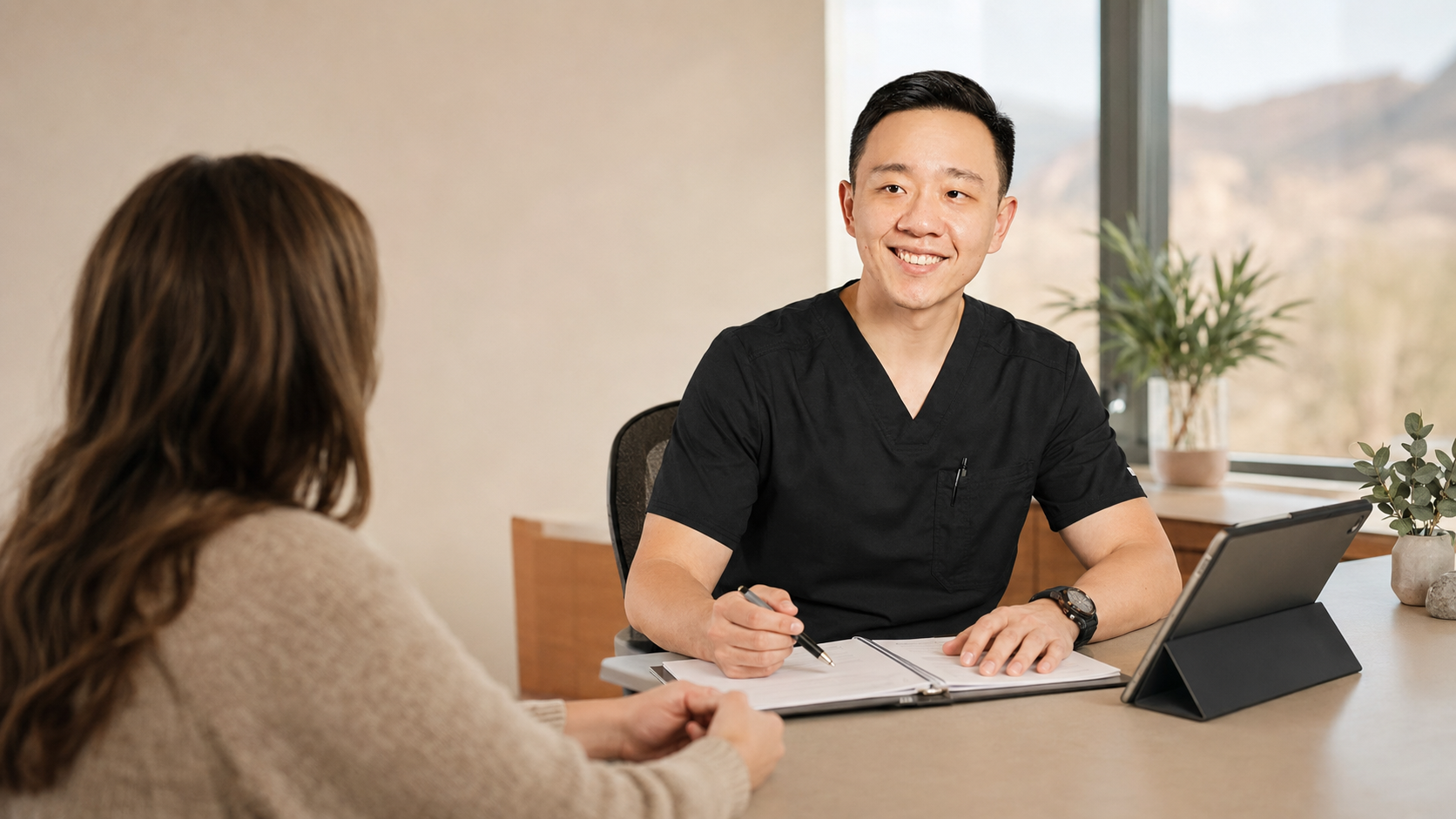 Dr. Hu discussing Arizona medical marijuana certification with a patient