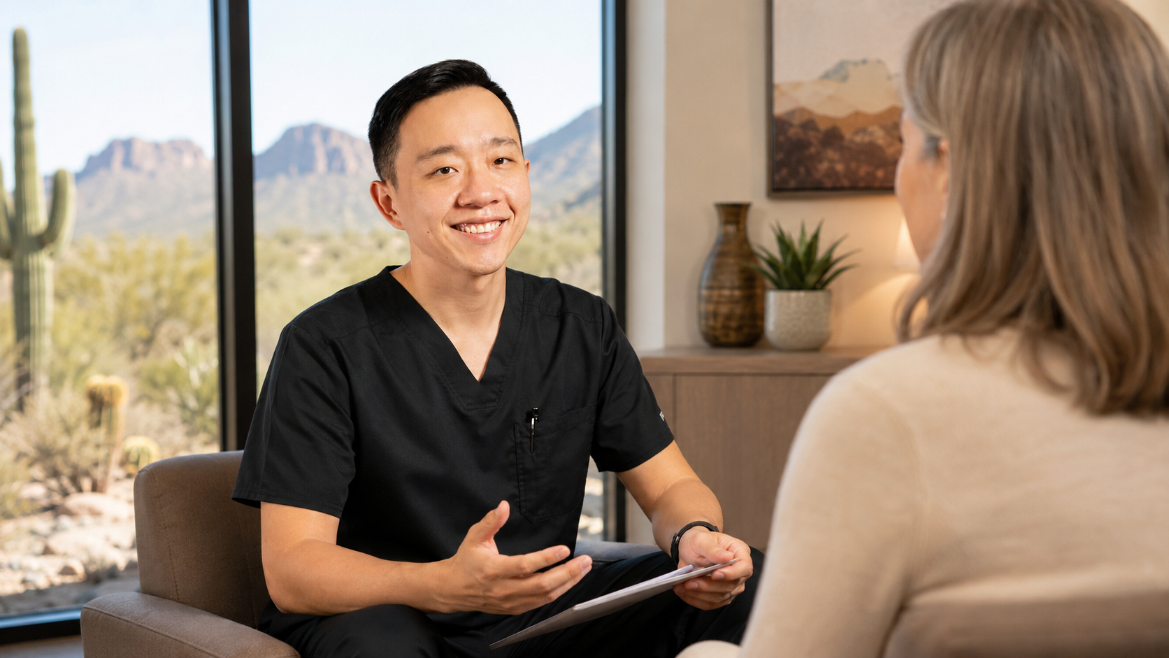 Dr. YiQiu Hu discussing personalized medical care with a patient from Buckeye, Arizona
