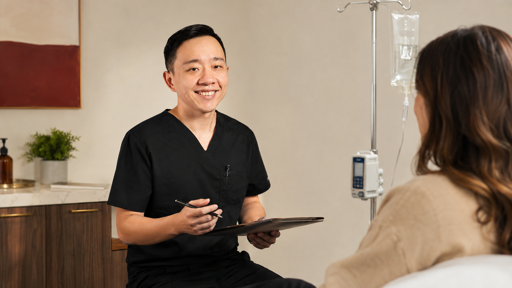 Dr. Hu discussing physician-guided IV therapy with a patient in Arizona