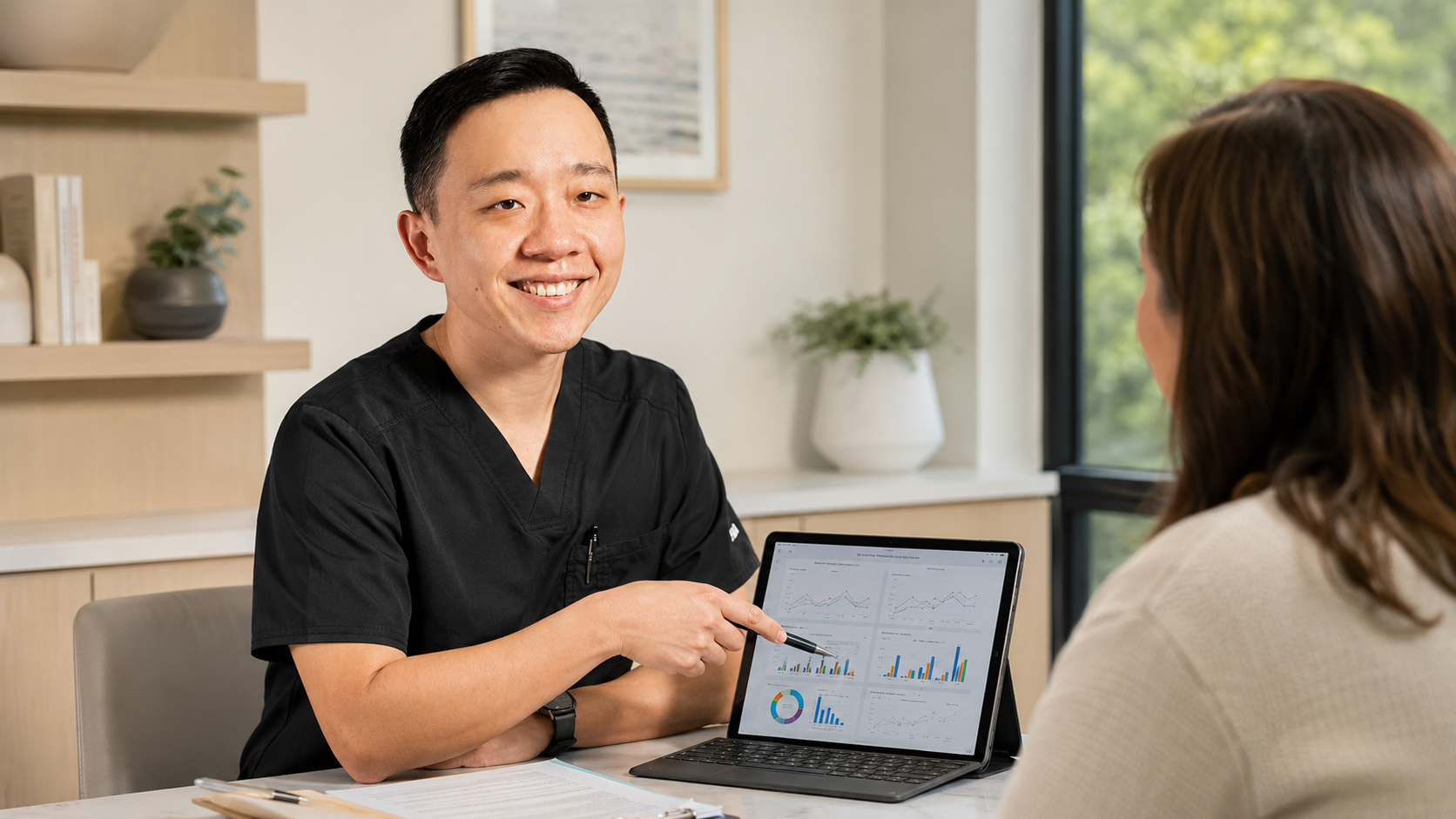 Concierge physician coordinating chronic medical care with specialists and reviewing patient records
