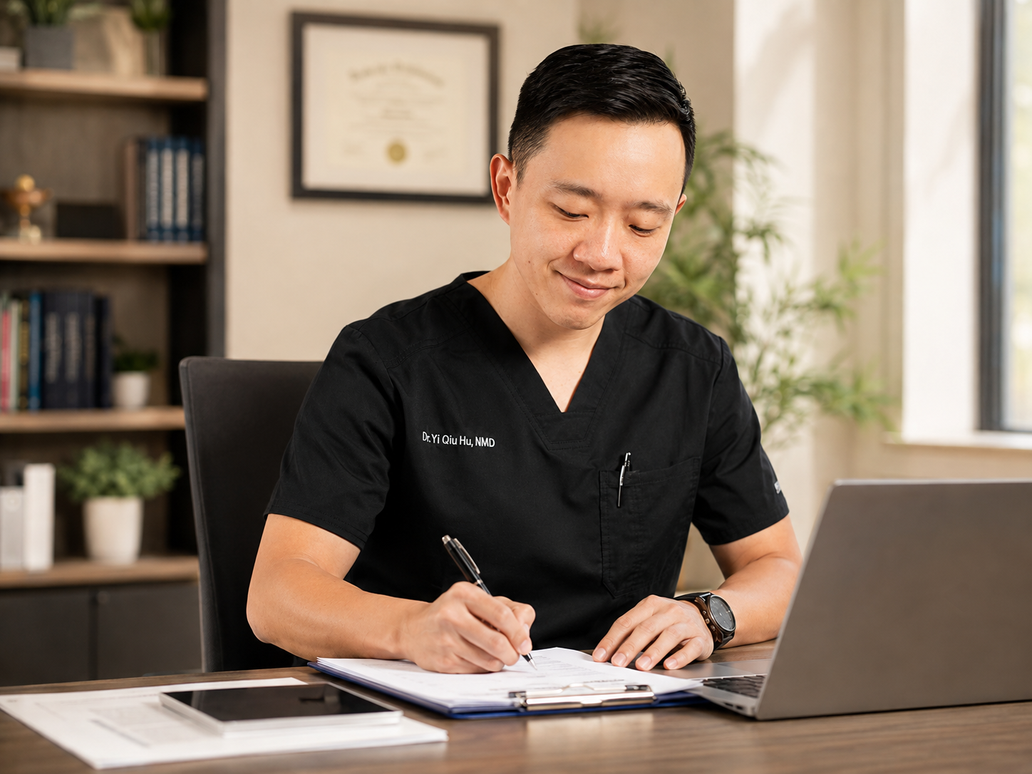 Dr. Hu reviewing medical documentation and patient records