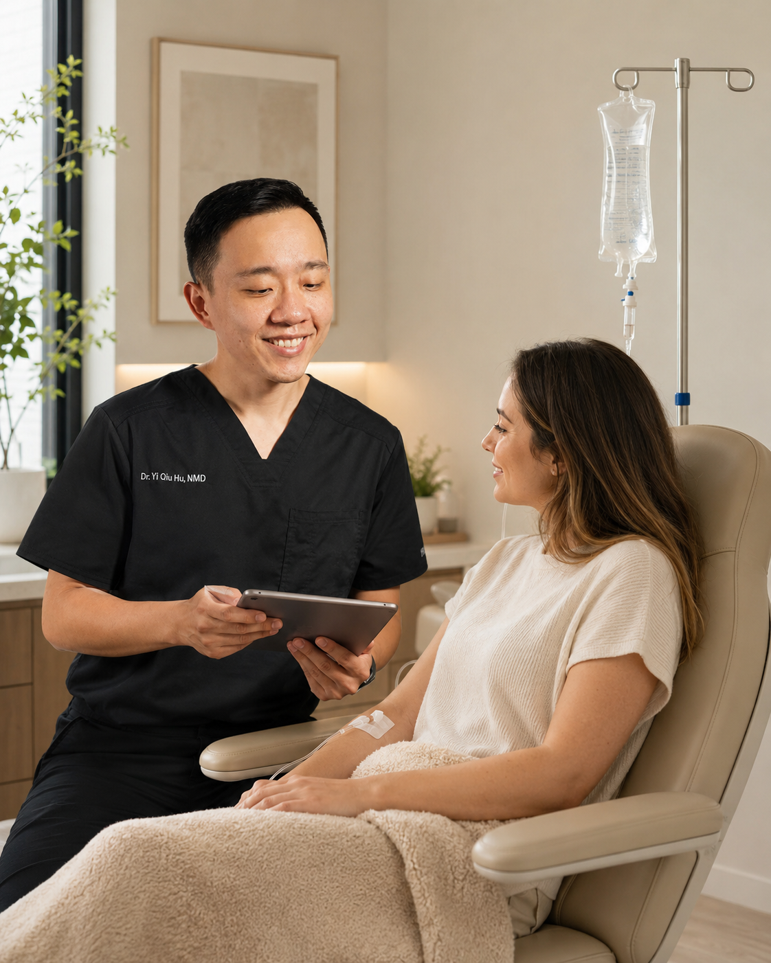 Dr. Hu reviewing a personalized IV nutrient therapy plan with a patient