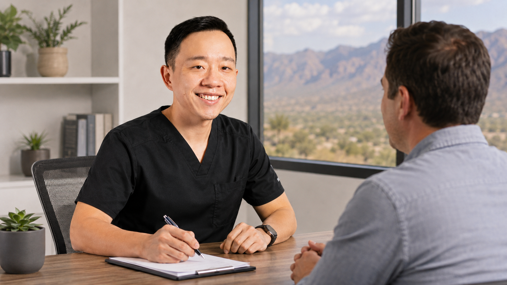Dr. YiQiu Hu discussing a personalized concierge medical plan with an Arizona patient