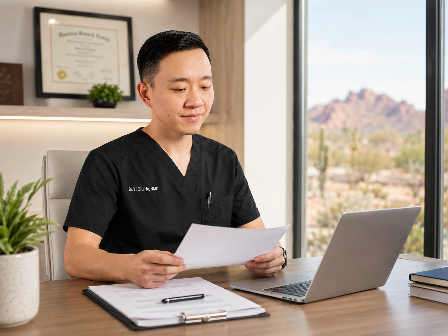 Dr. Hu reviewing medical documentation and patient records in Arizona