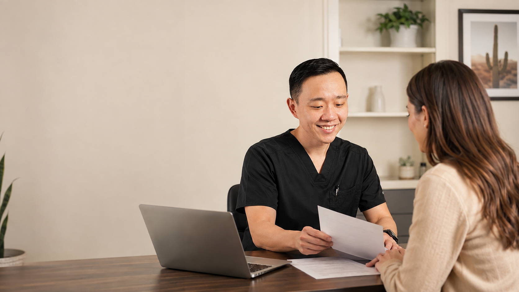 Dr. Hu reviewing Arizona medical marijuana certification documents with a patient