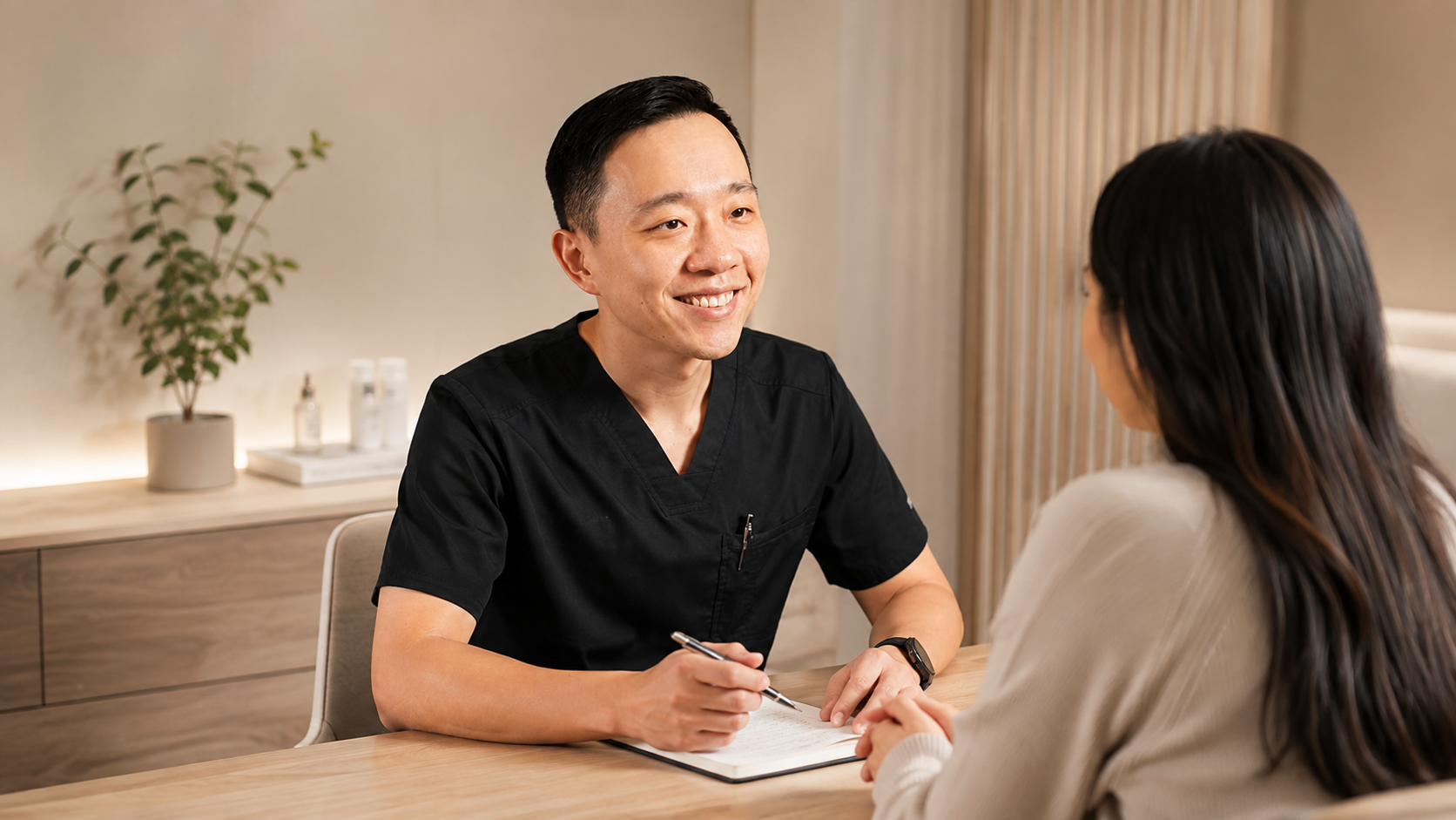 Dr. Hu explaining naturopathic medicine and personalized treatment options to a patient