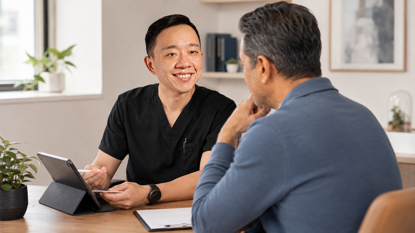 Physician reviewing laboratory trends and chronic condition monitoring with a concierge medicine patient