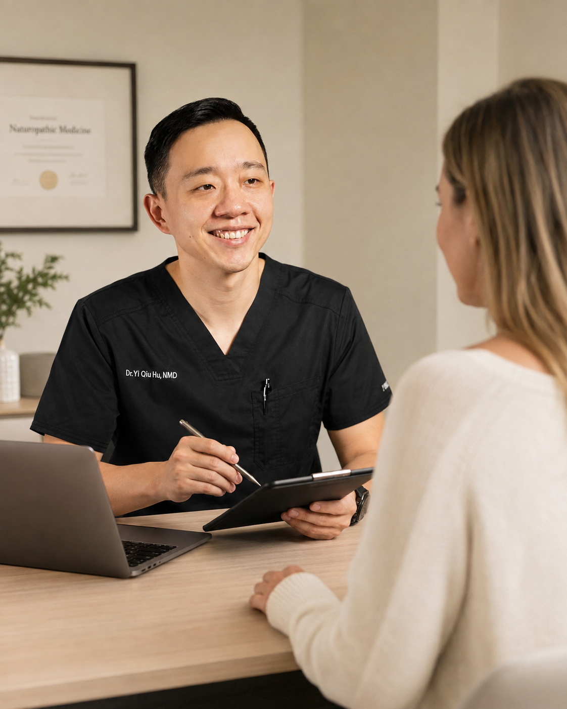 Dr. Hu reviewing medical history with a patient during an Arizona medical marijuana evaluation