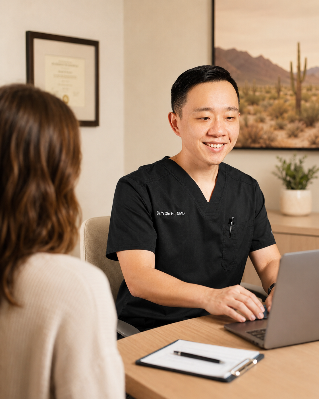 Dr. Hu reviewing medical history with an Arizona patient during a medical marijuana evaluation.