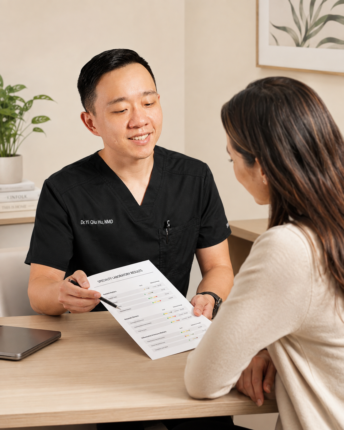 Dr. Hu reviewing specialty laboratory results with a patient during a personalized consultation