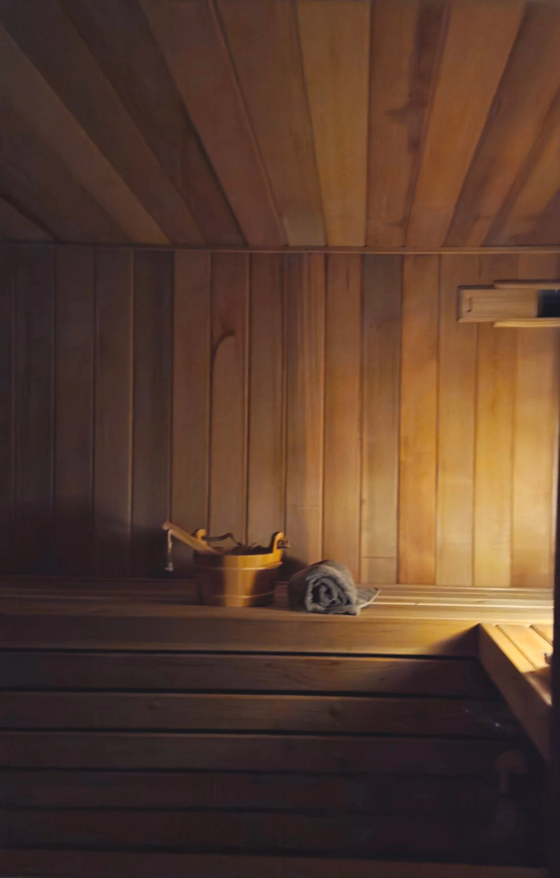 Inside a wooden sauna, a wooden bucket with a ladle, a rolled towel, and a stone are placed on the bench.