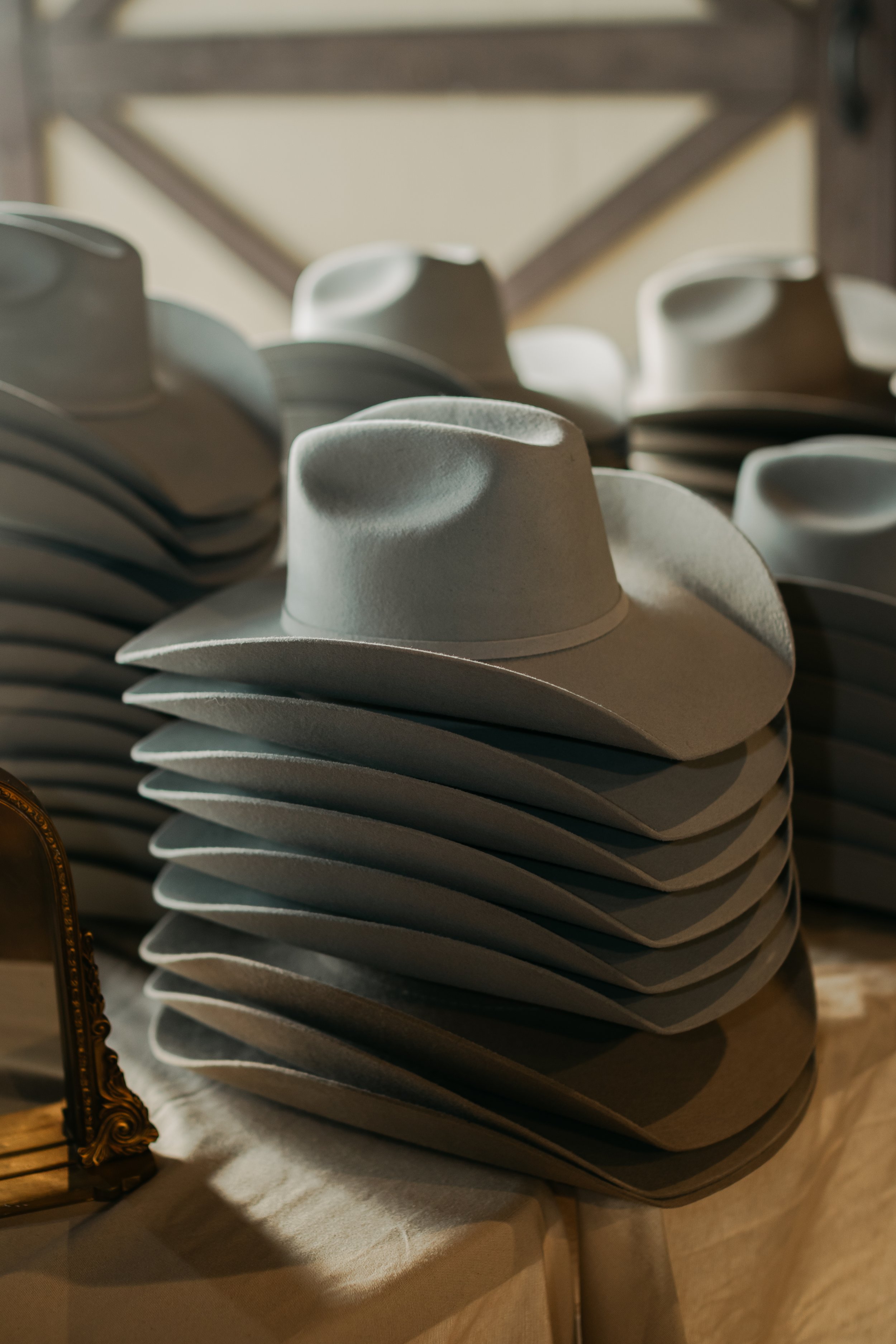 Stack of white cowboy hats on display.
