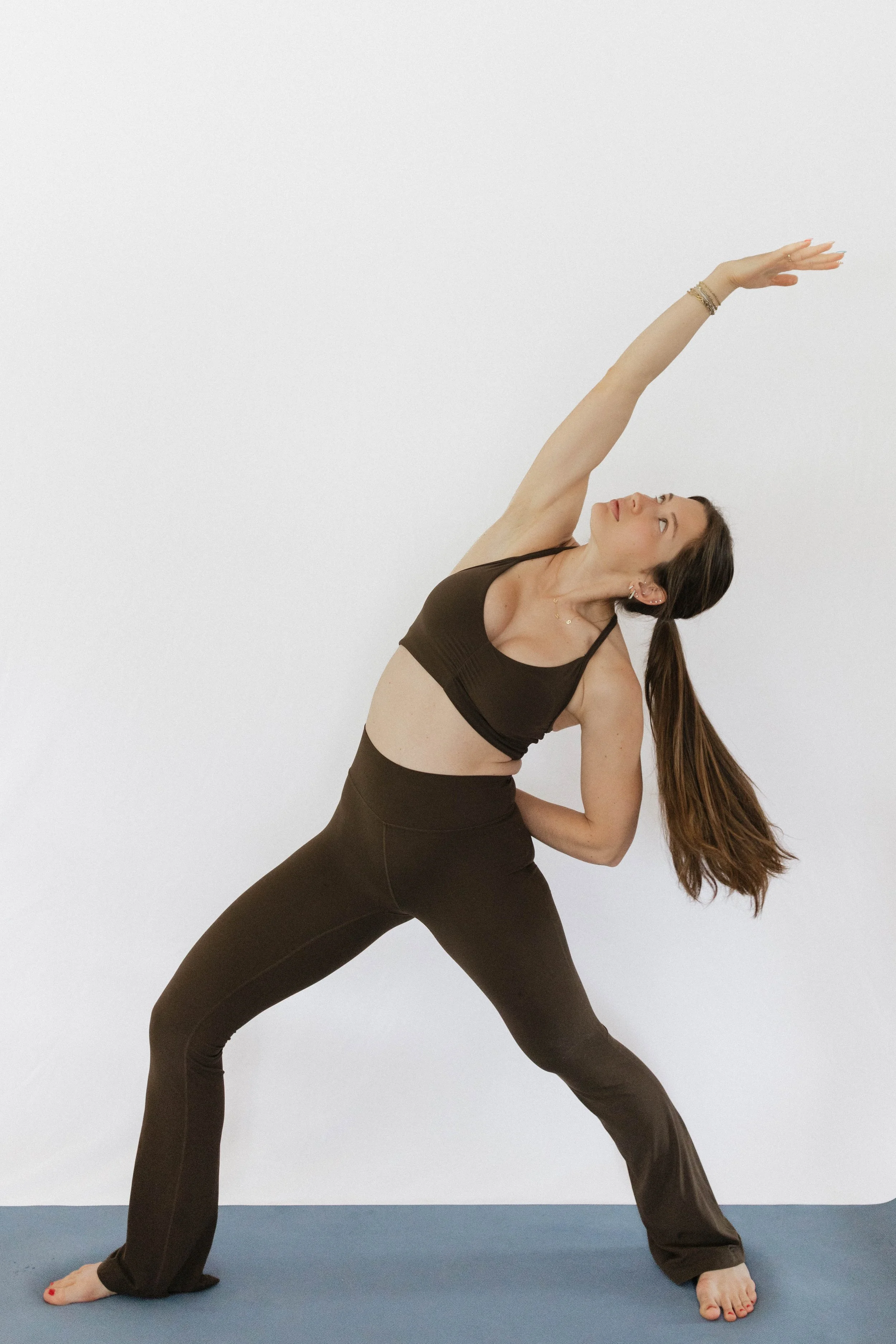 Woman in a yoga stretch pose, representing the mindset and lifestyle coaching in The Inner Strength Method's GLP-1 weight loss program