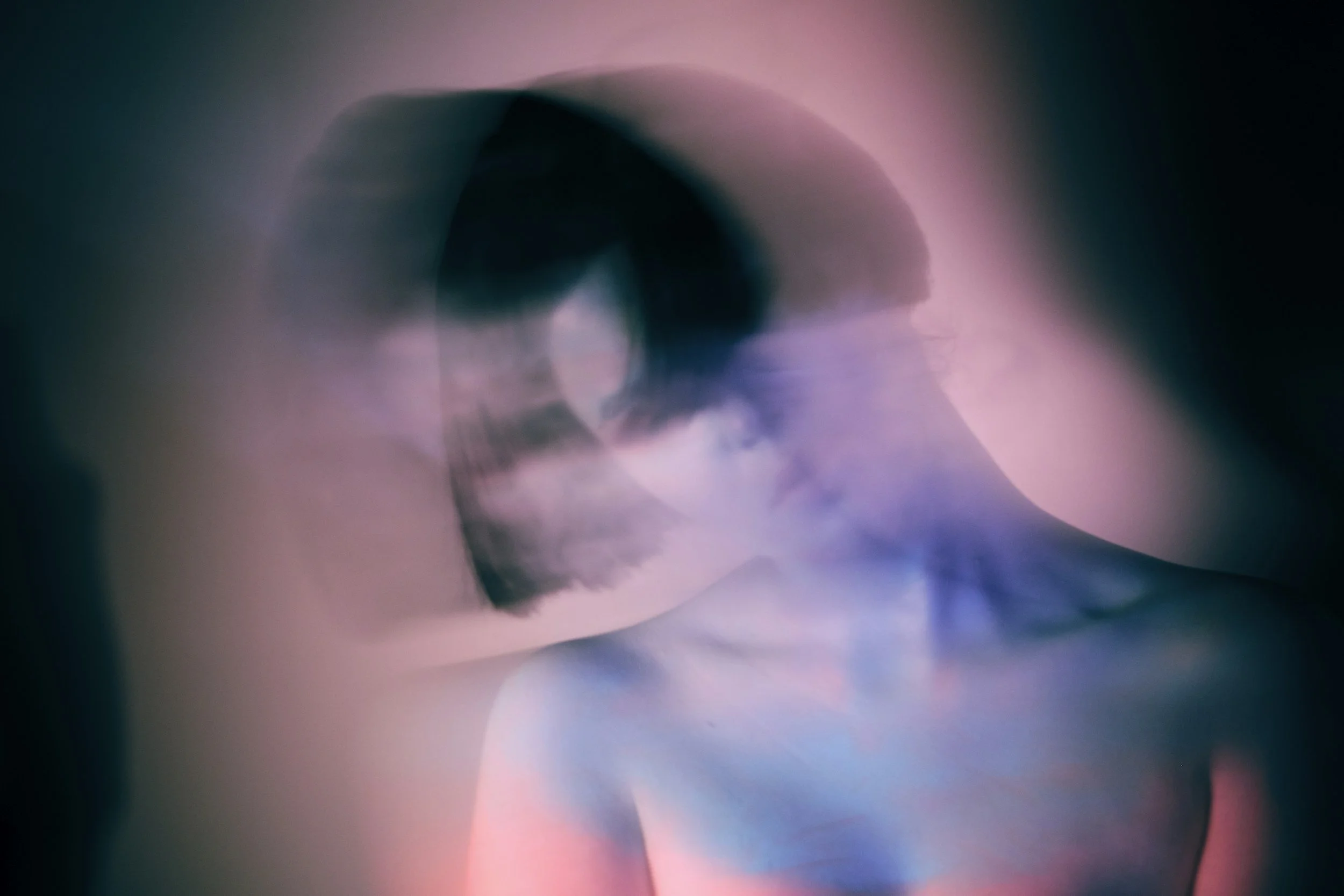 Close-up of a vinyl record player with a blurred, abstract background.