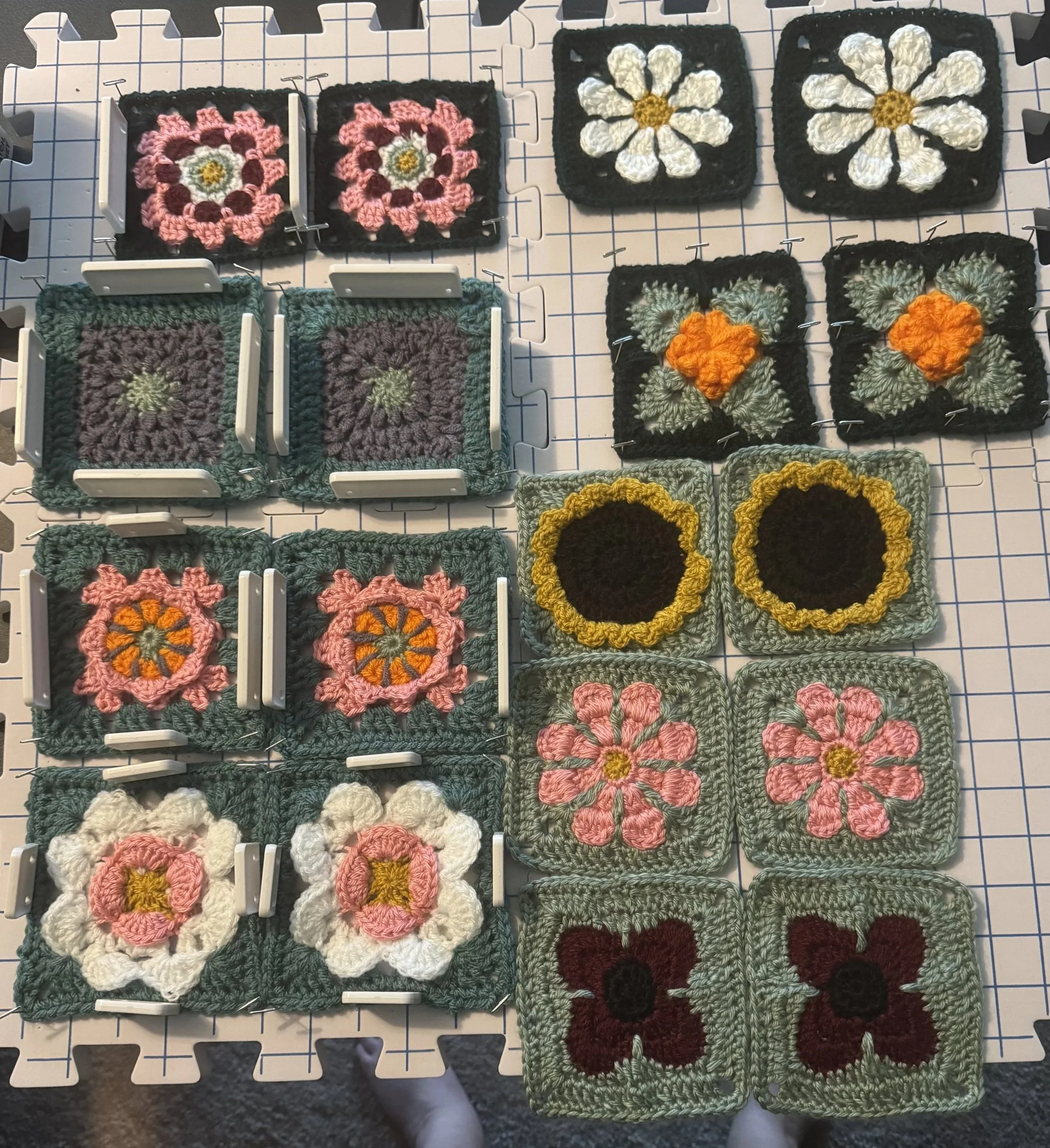 Eighteen granny squares, crocheted as components for a dress pattern.