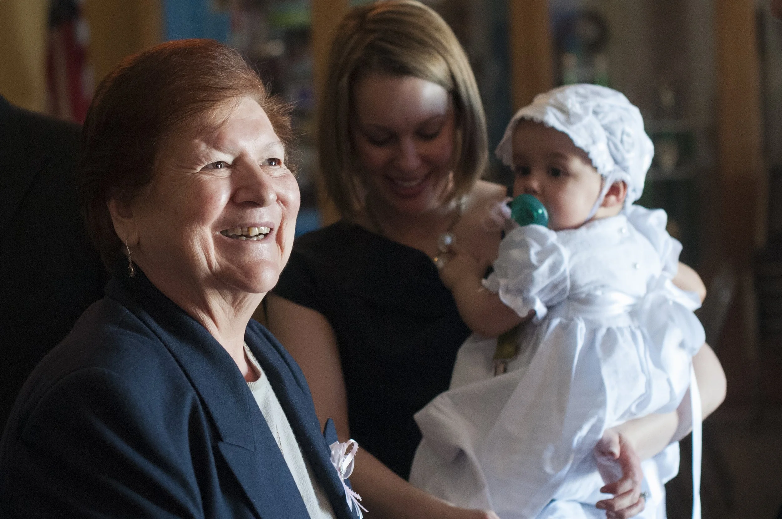 Sophia Balomas smiles after welcoming Lena Balomas into the Church at St. Nicholas Greek Orthodox Church in Baltimore, Maryland, April 4, 2015.
