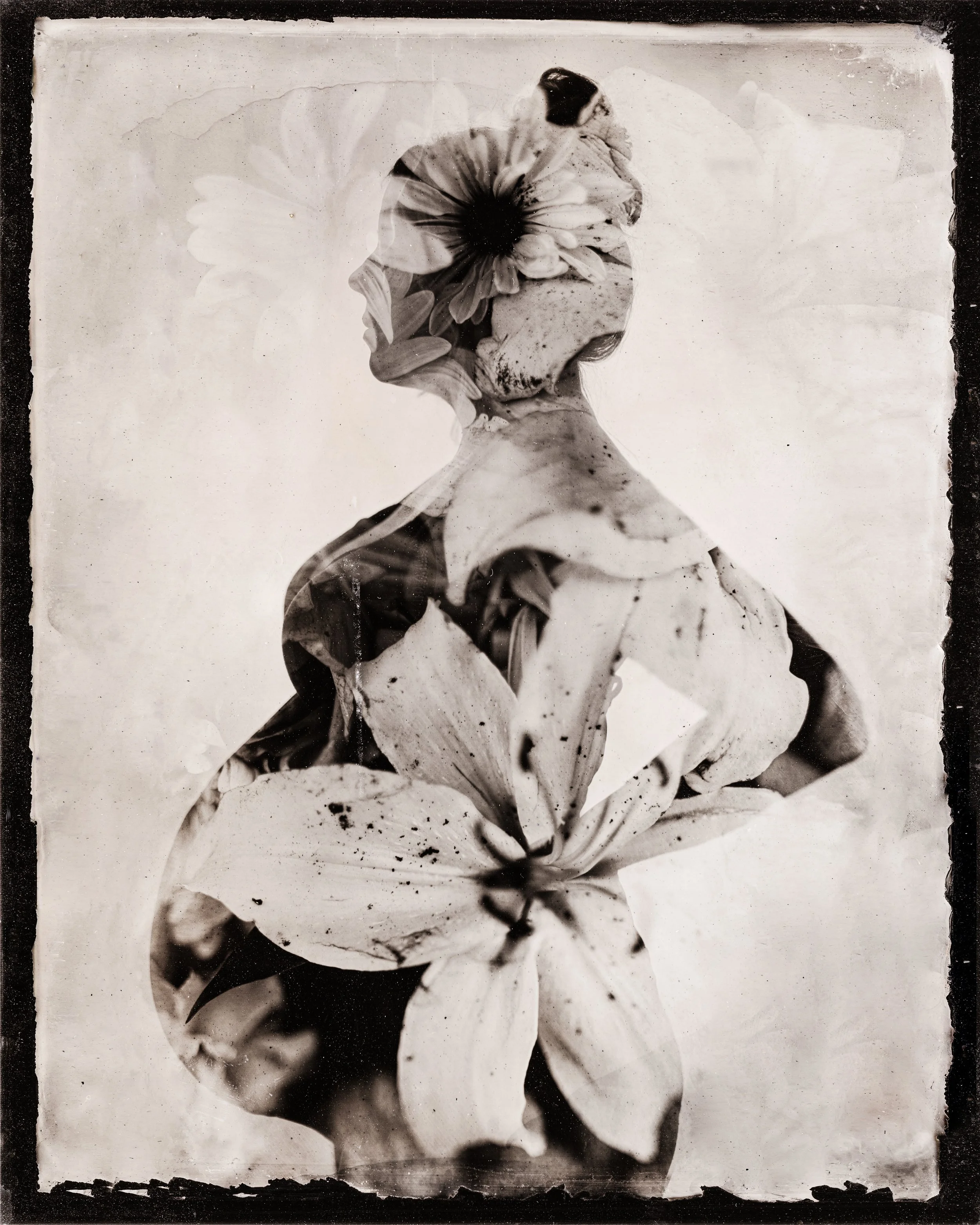 Black and white artistic photo blending a silhouette of a person's profile with flowers and abstract patterns.