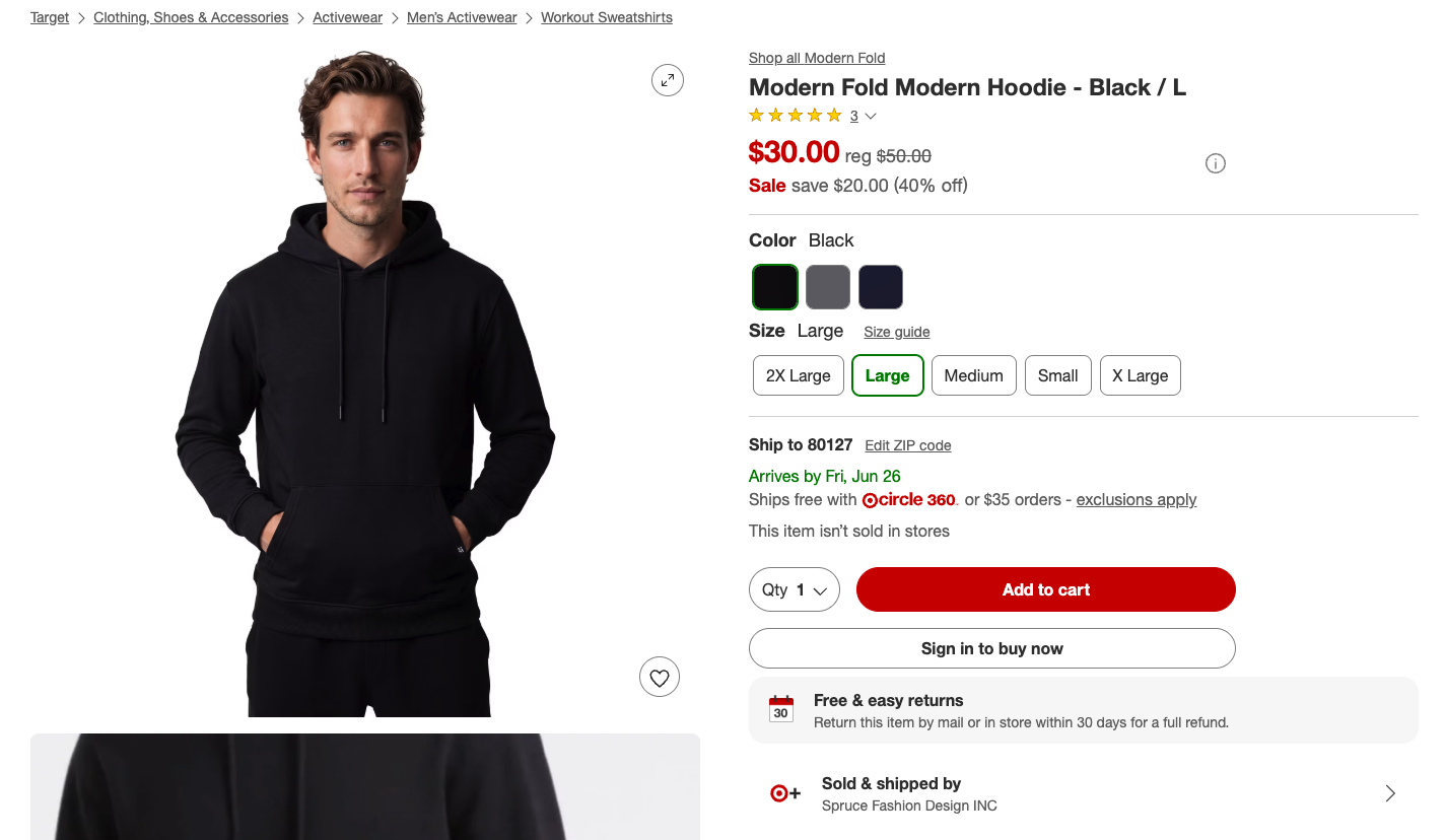A young man wearing a black modern hooded sweatshirt with a front pocket, standing with hands in pockets, looking directly at the camera against a white background.